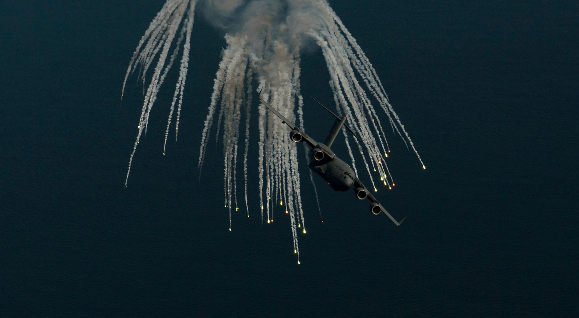 A C-17 Globemaster III assigned to 315th Airlift Wing out of Joint Base Charleston, S.C., deploys flares as part of an operational readiness exercise Nov. 17, 2018. The exercise provided the 315th Operations Group with hands-on training in a variety of airlift and aeromedical evacuation tactics during simulated combat events. (U.S. Air Force photo by Staff Sgt. Nicholas A. Priest)