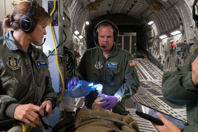 Air Force Reserve Lt. Col. David Ferguson and Tech. Sgt. Brigid Dye perform medical care to a simulated patient on a C-17 Globemaster III during an operational readiness exercise near Charleston, S.C., Nov. 17, 2018. The exercise provided the 315th Operations Group with hands-on training in a variety of airlift and aeromedical evacuation tactics during simulated combat events. Ferguson and Dye are both assigned to the 315th Aeromedical Evacuation Squadron. (U.S. Air Force photo by Staff Sgt. Nicholas A. Priest)