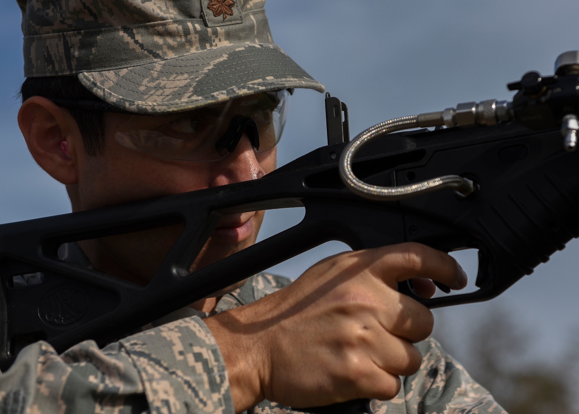 U.S. Air Force Maj. Benjamin Moran, U.S. Embassy Security Cooperation Office operations officer takes aim during a non-lethal weapons demonstration at Joint Base Langley-Eustis, Virginia, Nov. 8, 2018.