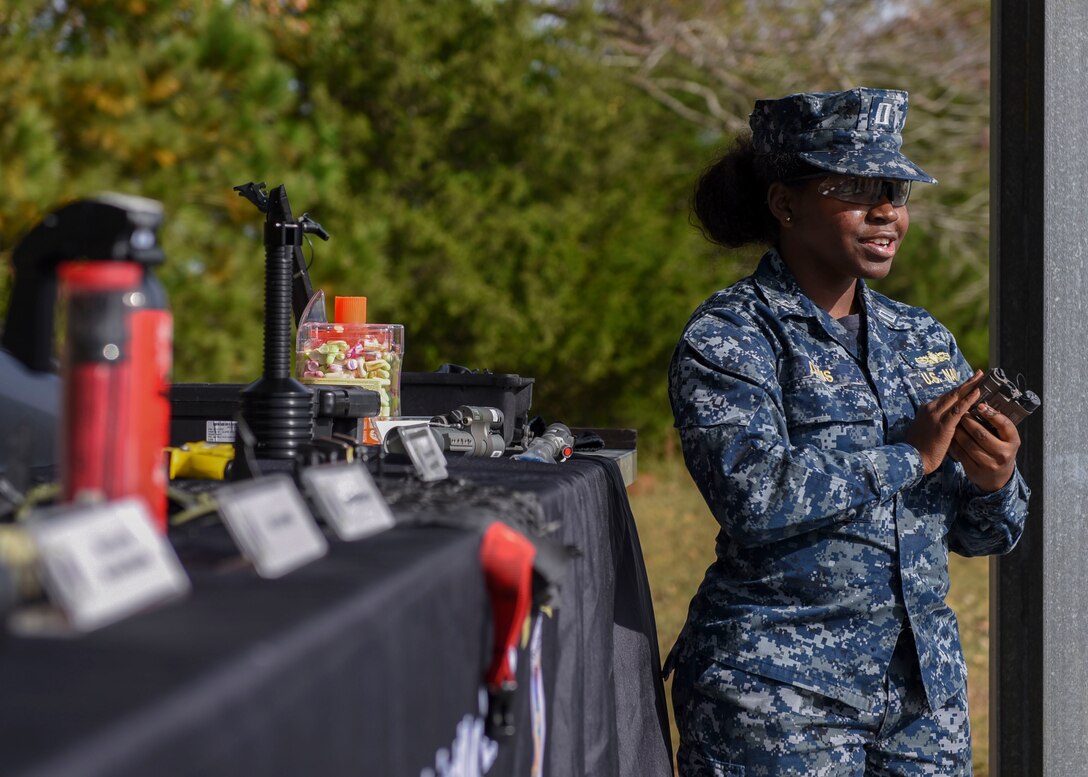 U.S. Navy 1st Lt. Shannon Davis, Joint Non-Lethal Weapons Program surface warfare officer, talks about weapons options during a demonstration at Joint Base Langley-Eustis, Virginia, Nov. 8, 2018.