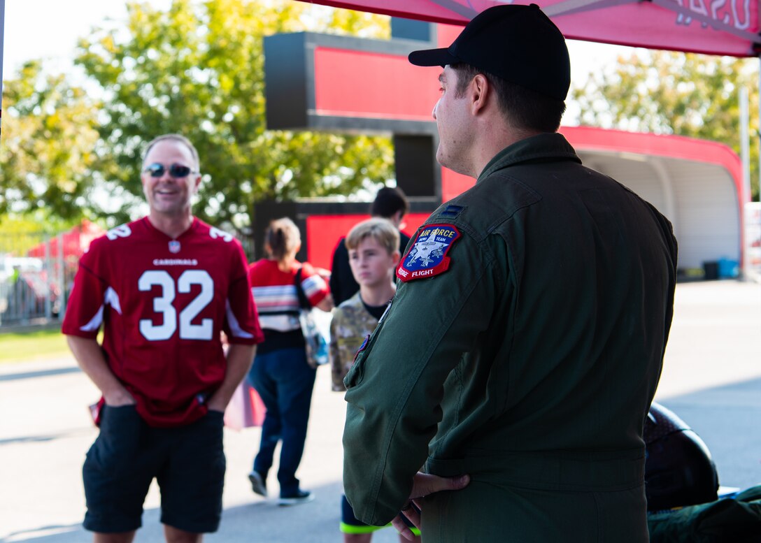 Capt. Andrew “Dojo” Olson, F-35 Heritage Flight Team pilot and commander, speaks with an Arizona Cardinals fan Nov. 18, 2018, at the State Farm Stadium, Glendale, Ariz.