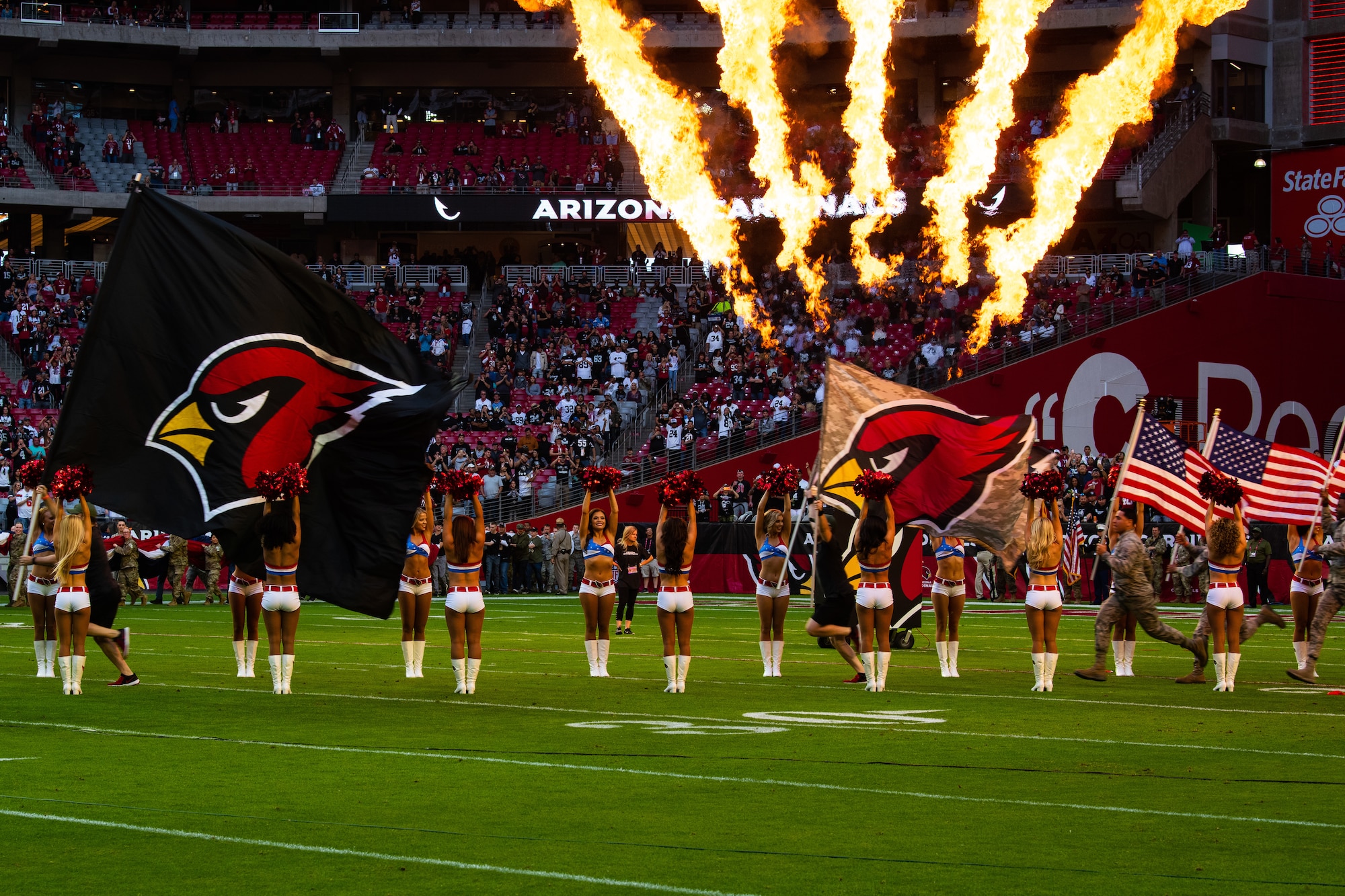 Airmen assigned to the 56th Fighter Wing, run onto the State Farm Stadium field during the Arizona Cardinals Salute to Service pre-game ceremony, Nov. 18, 2018 at Glendale, Ariz.