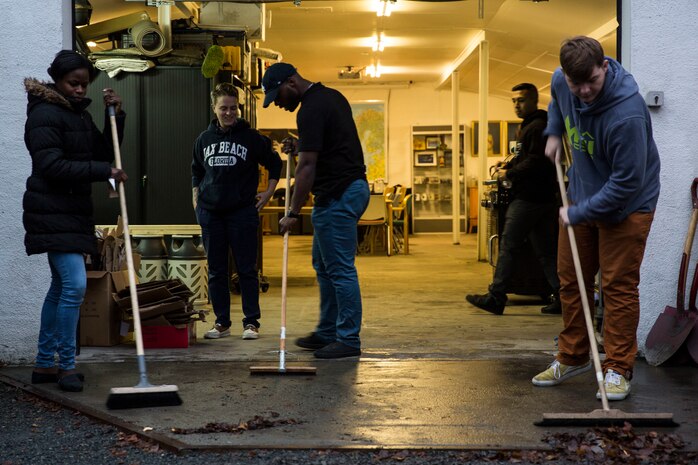 Sailors sweep the garage of the Veterans Moter Veterans Home in Oslo, Norway Nov. 15, 2018.
