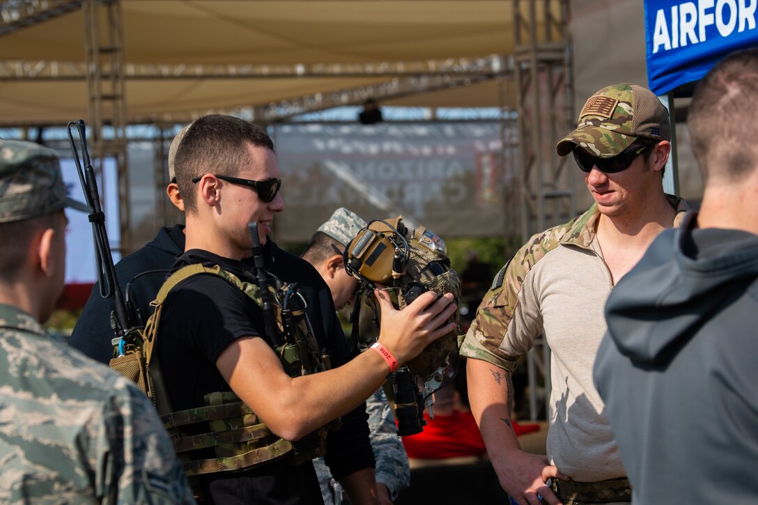 Members from the 17th Special Tactics Squadron, Fort Beinning, GA, teach civilians how to don special tactics equipment before the Arizona Cardinals Salute to Service game, Nov. 18, 2018, at the State Farm Stadium, Glendale, Ariz.