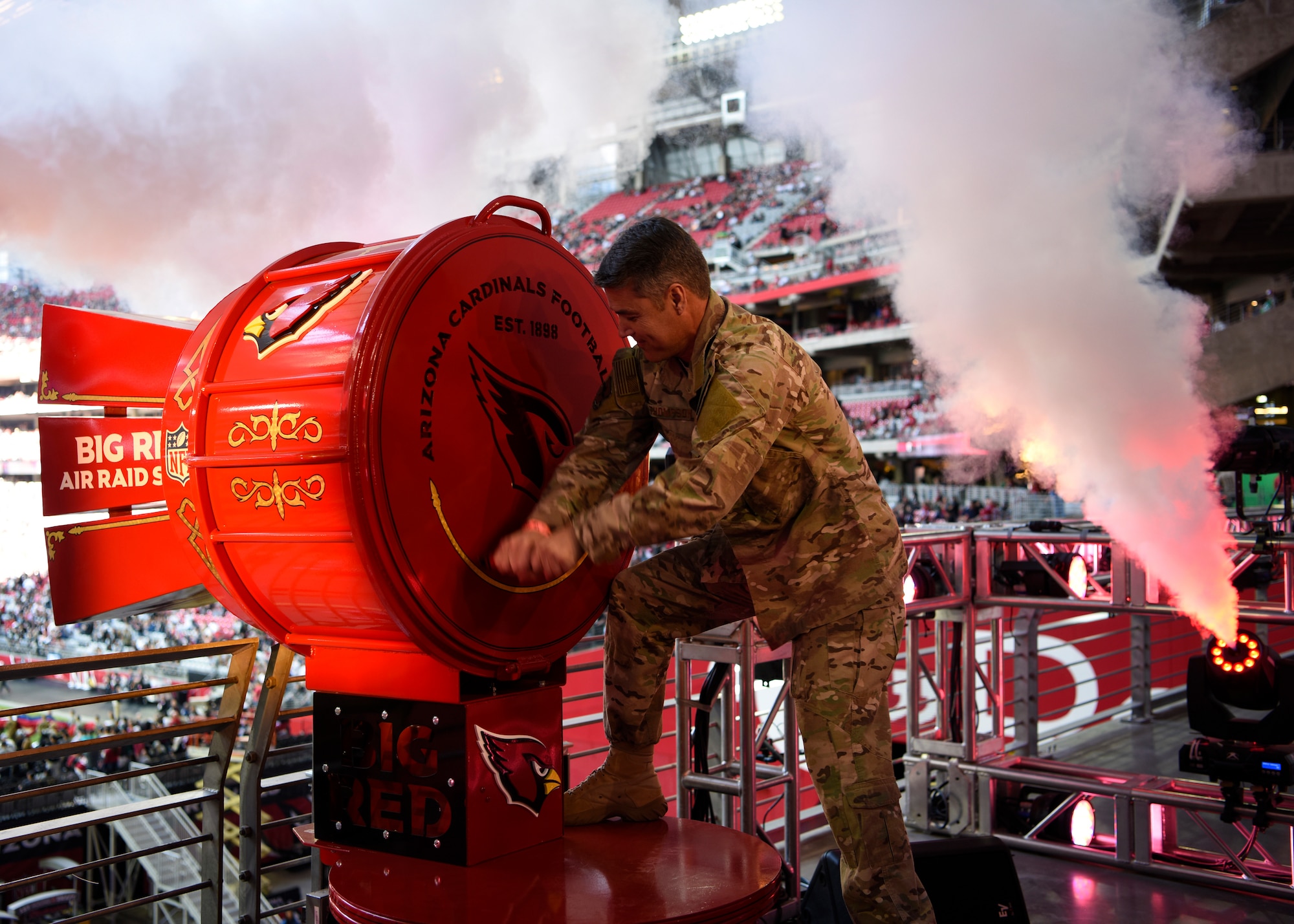 Chief Master Sgt. Ronald Thompson, 56th Fighter Wing command chief, cranks the “Big Red” air raid siren before the Arizona Cardinals Salute to Service game, Nov. 18, 2018, at State Farm Stadium, Glendale, Ariz.