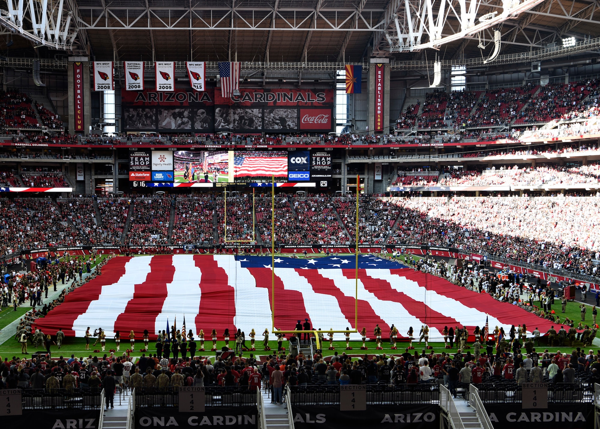 Airmen from Luke Air Force Base hold an American Flag during the National Anthem before the Arizona Cardinals Salute to Service game, Nov. 18, 2018, at State Farm Stadium, Glendale, Ariz.