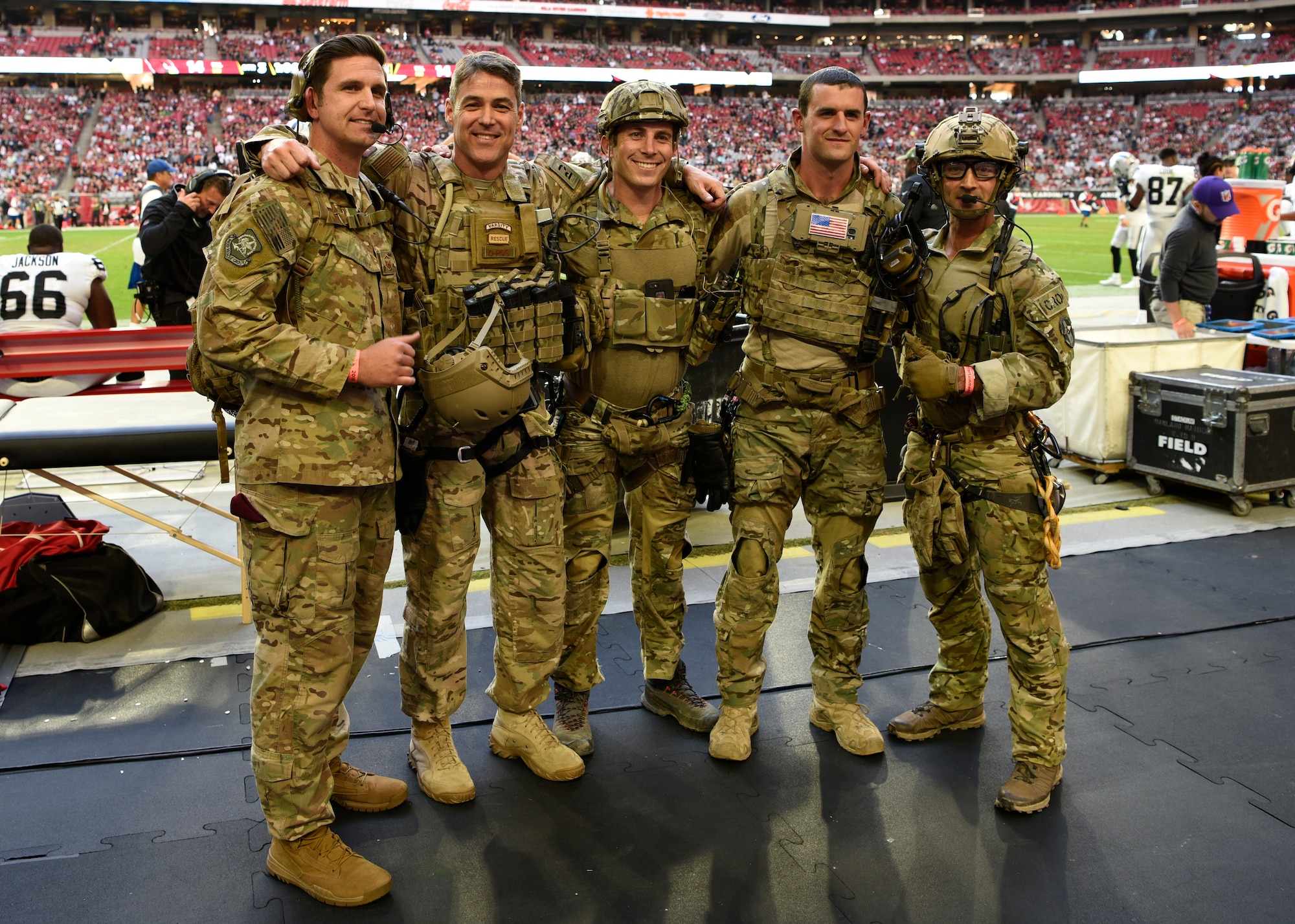 Chief Master Sgt. Ronald Thompson, 56th Fighter Wing command chief, poses for a picture with members of the 306th and 68th Rescue Squadrons, Davis-Monthan Air Force Base, during the Arizona Cardinals Salute to Service game, Nov. 18, 2018, at State Farm Stadium, Glendale, Ariz.