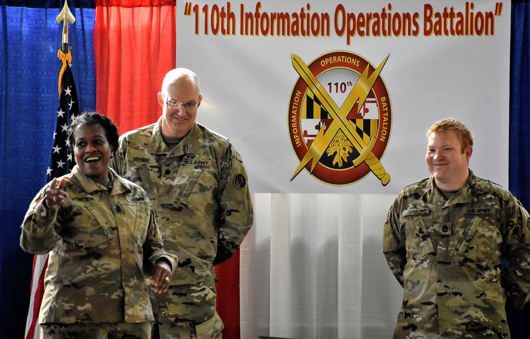 U.S. Army Sgt. 1st Class Quintin C. Steele, intelligence specialist, stands with Sgt. Maj. Perlisa D. Wilson, senior enlisted leader, and Lt. Col. Stephen P. Gerber, a senior intelligence officer, during a promotion ceremony at the 110th Information Operations Battalion Nov 18, 0218, in Annapolis, Md. Steele's promotion speech sparked an emotional expression of gratitude to his unit for the support he received as his family lived through the devastation of Hurricane Michael in Panama City, Fla.