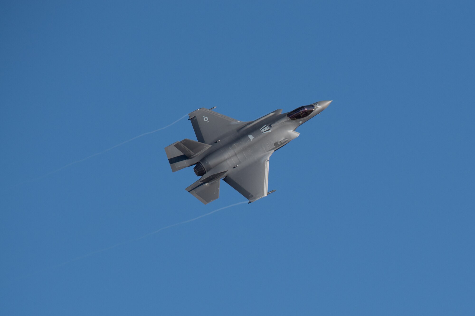A F-35A Lightning II from the 388th and 419th Fighter Wing fly by as part of a combat power exercise at Hill Air Force Base, Utah. The exercise aims to confirm their ability to quickly employ a large force of jets against air and ground targets, and demonstrate the readiness and lethality of the F-35 Lightning II. As the first combat-ready F-35 units in the Air Force, the 388th and 419th FWs are ready to deploy anywhere in the world at a moment’s notice. (United States Air Force photo/Cynthia Griggs)