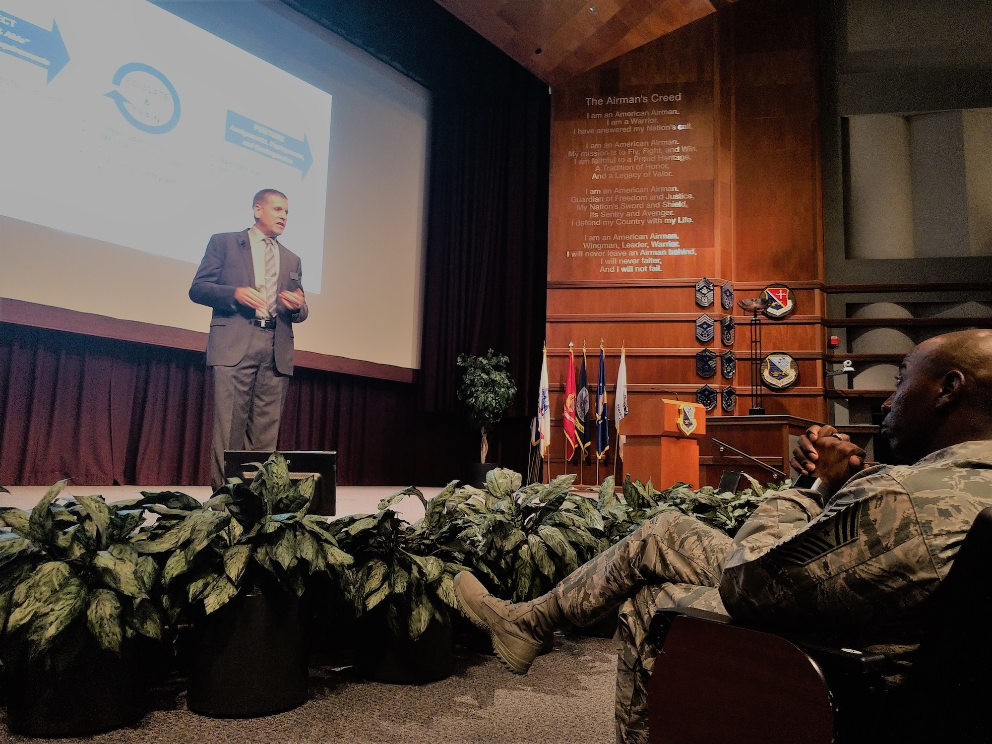 Mr. Howard Ward, Director of the Air Force Culture and Language Center, speaks to Chief Master Sergeant Kaleth O. Wright about the Culture and Language Center at the Senior Non Commissioned Officer Academy at Maxwell AFB Gunter-Annex, AL on 14 August, 2018. The presentation was part of a series held as top enlisted leaders from international partner nations attended a summit.