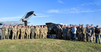 Airmen from the 437th Operations Group special operations unit pose in front of their new training helicopter Nov. 16, 2018, at Joint Base Charleston, S.C.