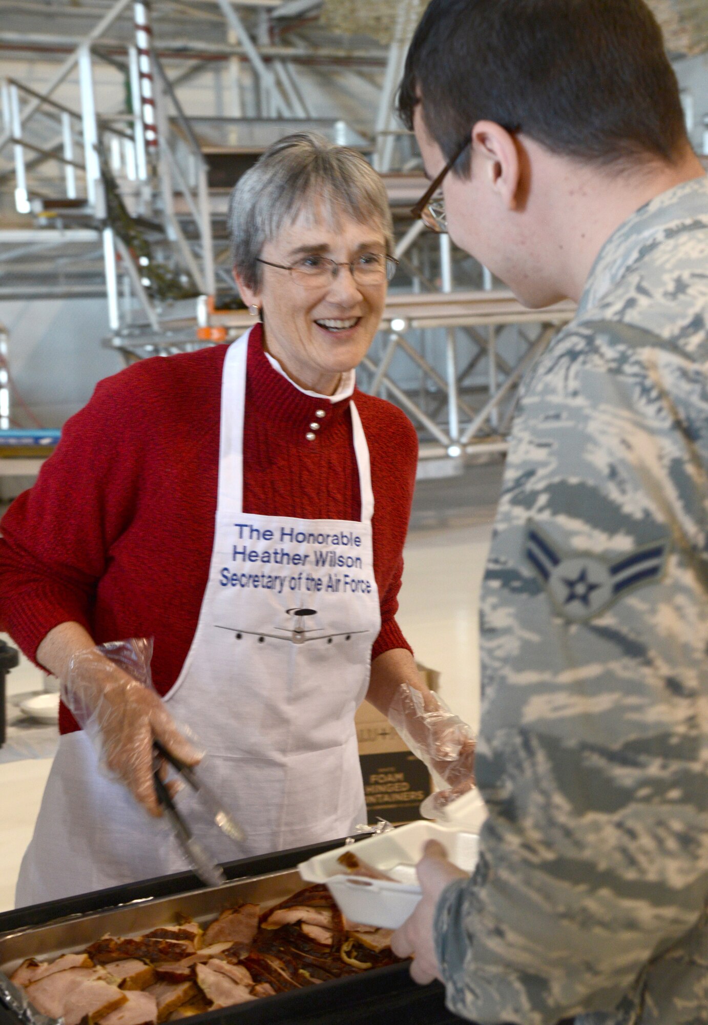 Secretary of the Air Force Heather Wilson took the opportunity to help serve Thanksgiving dinner to members of the 552nd Air Control Wing during her visit to Tinker Air Force Base Nov. 16. Wilson is shown here serving ham-slices to an Airman 1st Class of the 552nd ACW.
