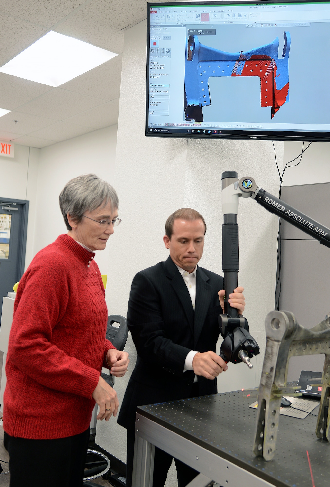 Nathan Pitcovich, Reverse Engineering and Critical Tooling Lab engineer, demonstrates a Romer Arm, which scans parts, to Secretary of the Air Force Heather Wilson, during her visit to Tinker Air Force Base Nov. 16. Wilson toured centers for innovation like the REACT lab and met with personnel responsible for sustaining the Air Force’s fleet of tanker, bomber and transport aircraft.