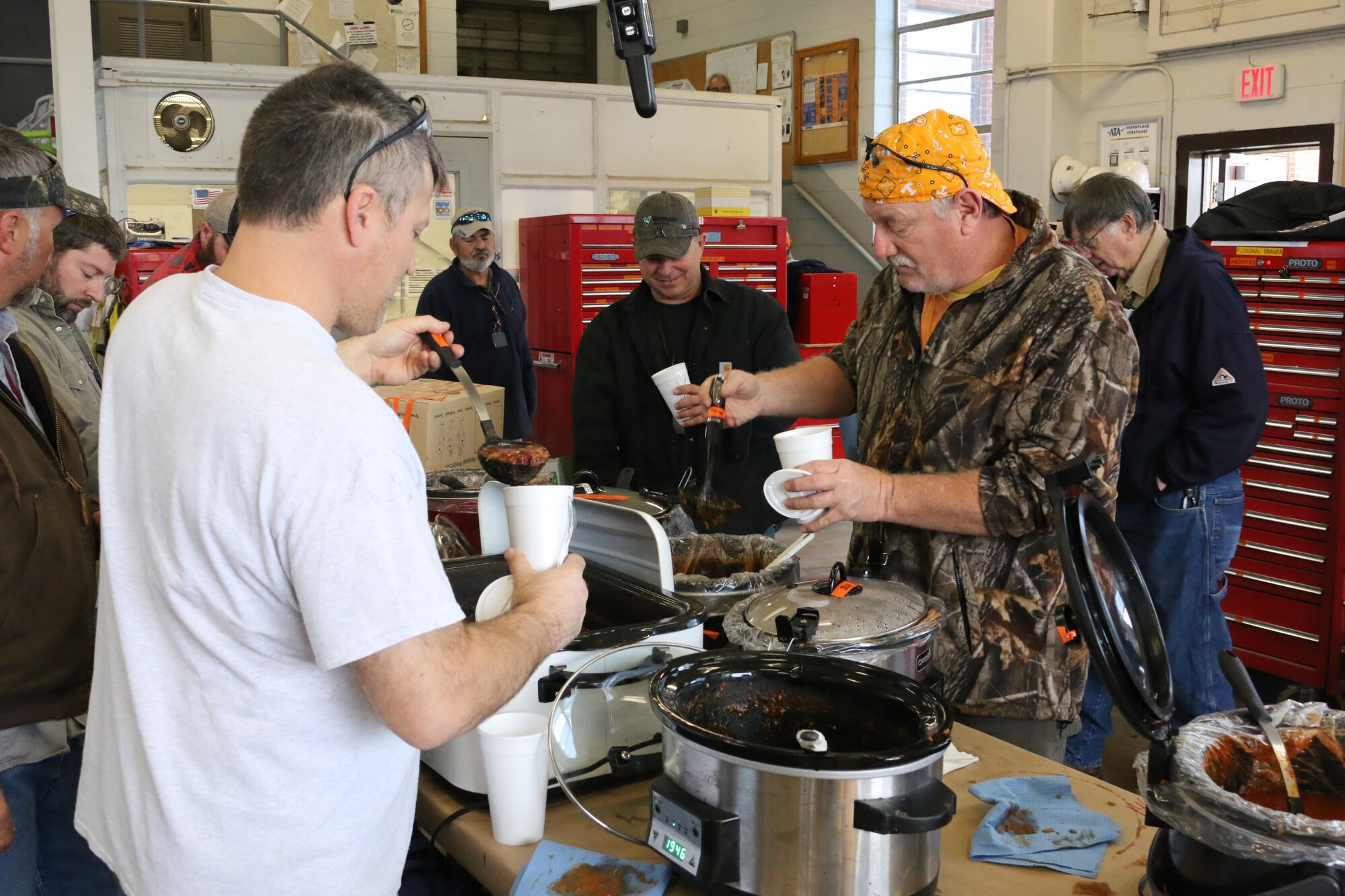 Personnel at Arnold Air Force Base enjoy some good food for a good cause during a chili sale held as part of the “International Brotherhood of Electrical Workers Kids for Christmas” fundraiser, which raises money to purchase Christmas gifts for area foster children. The Nov. 2 event, held at the Arnold AFB Power Control building, was widely attended by those on base. (U.S. Air Force photos by Bradley Hicks) (Image was altered by obscuring badges for security purposes)