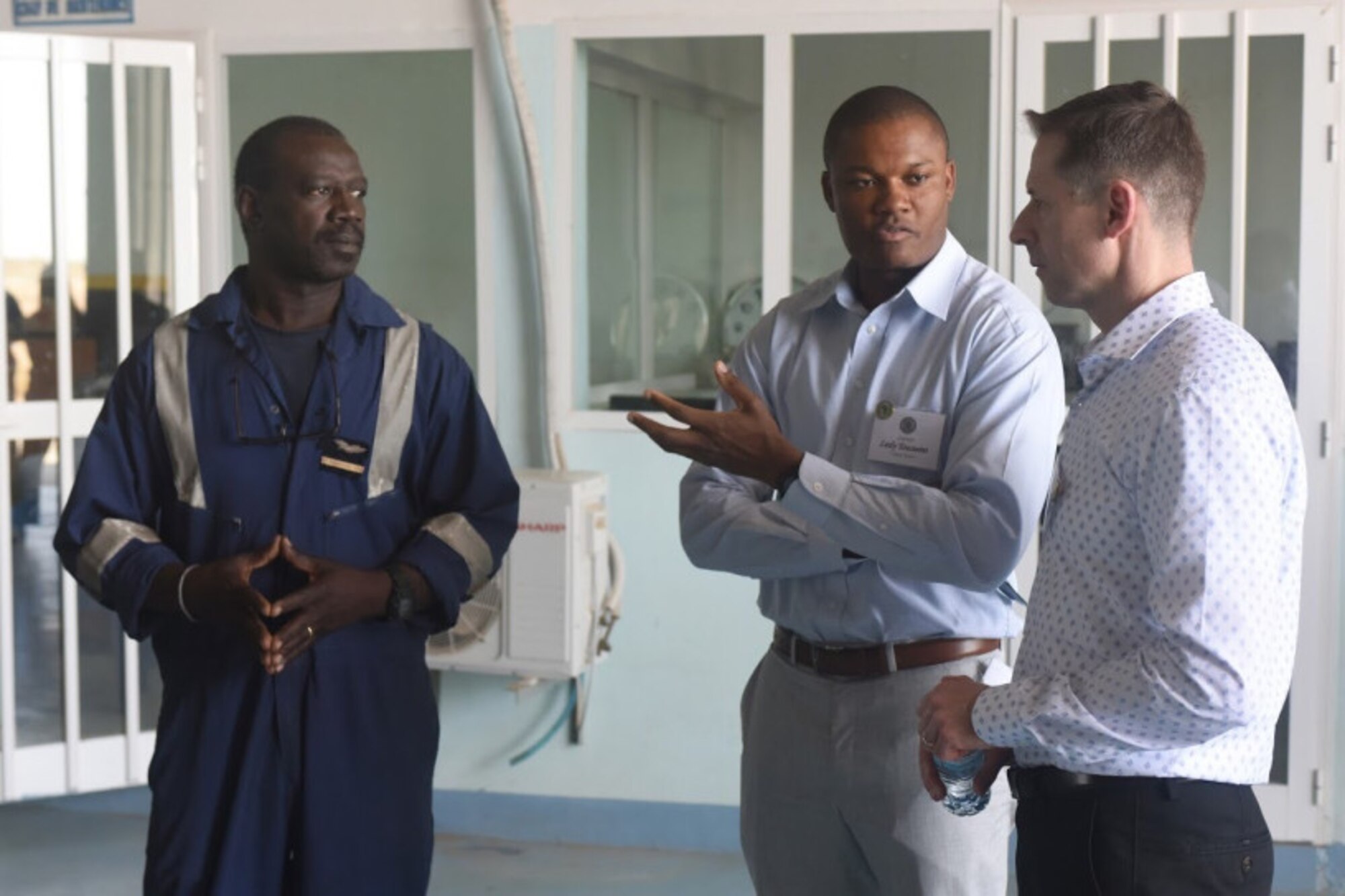 Capt. Lesly Toussaint (center), a Language Enabled Airman participant, translates for Brig. Gen. Dieter E. Bareihs (right), the Director of Plans, Programs and Analyses for Headquarters U.S. Air Forces in Europe and U.S. Air Forces Africa, during a conversation March 21 with a member of the 7th Groupement Operationel de l’Armee de l’Air during the Africa Partnership Flight in Thiès, Senegal.