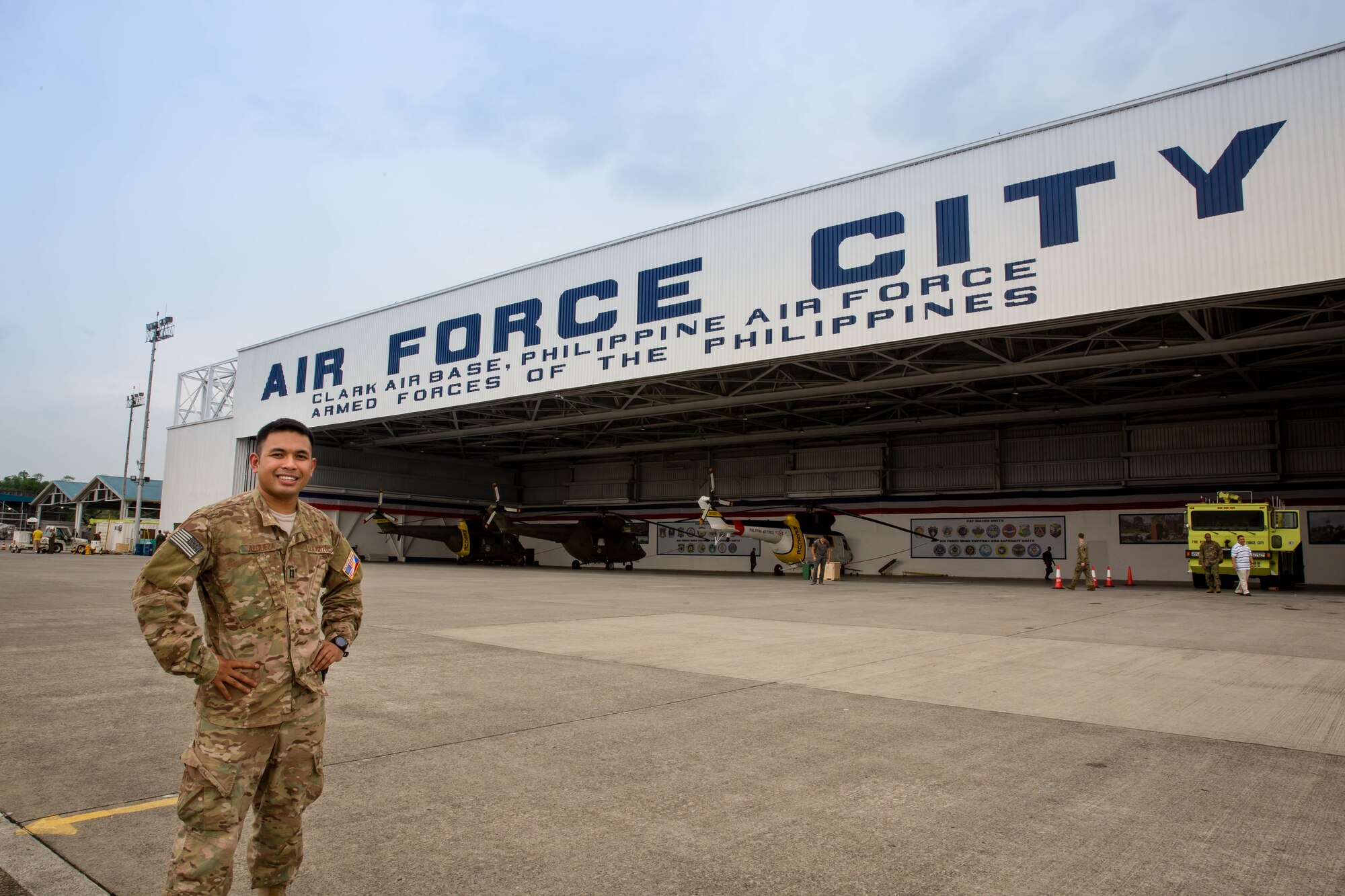 Capt. Patterson Aldueza stands in front of one of the hangars of Clark Air Base, Philippines, during his Language Intensive Training Event.
