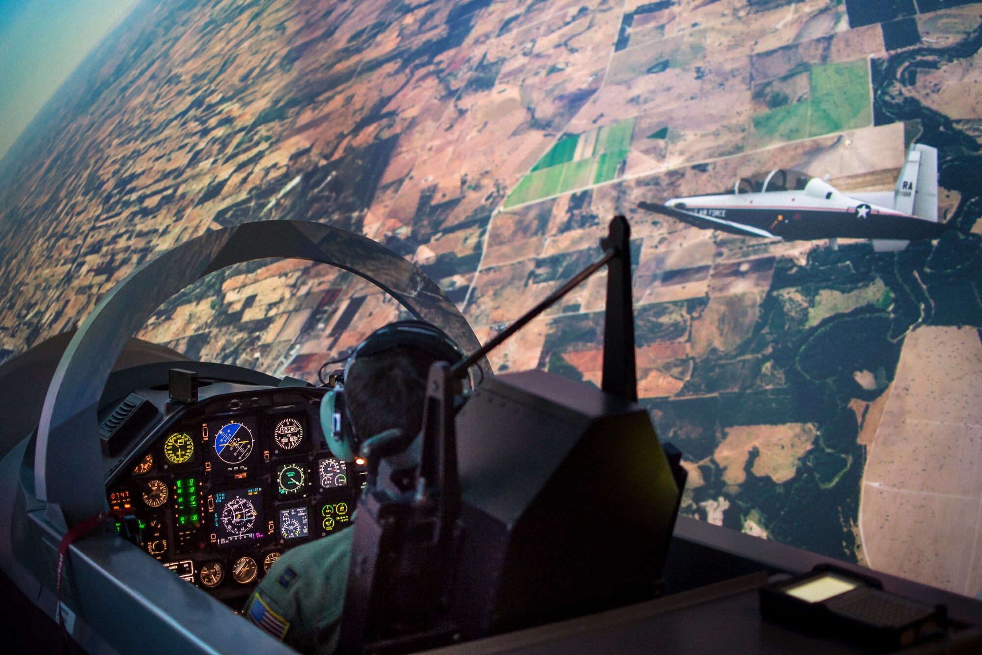 A U.S. Air Force student pilot flies a T-6A Texan II in formation inside a simulator Nov. 8, 2018 at Joint Base San Antonio - Randolph, Texas. Simulators enhance spatial awareness and communication skills that are essential for formation flight.