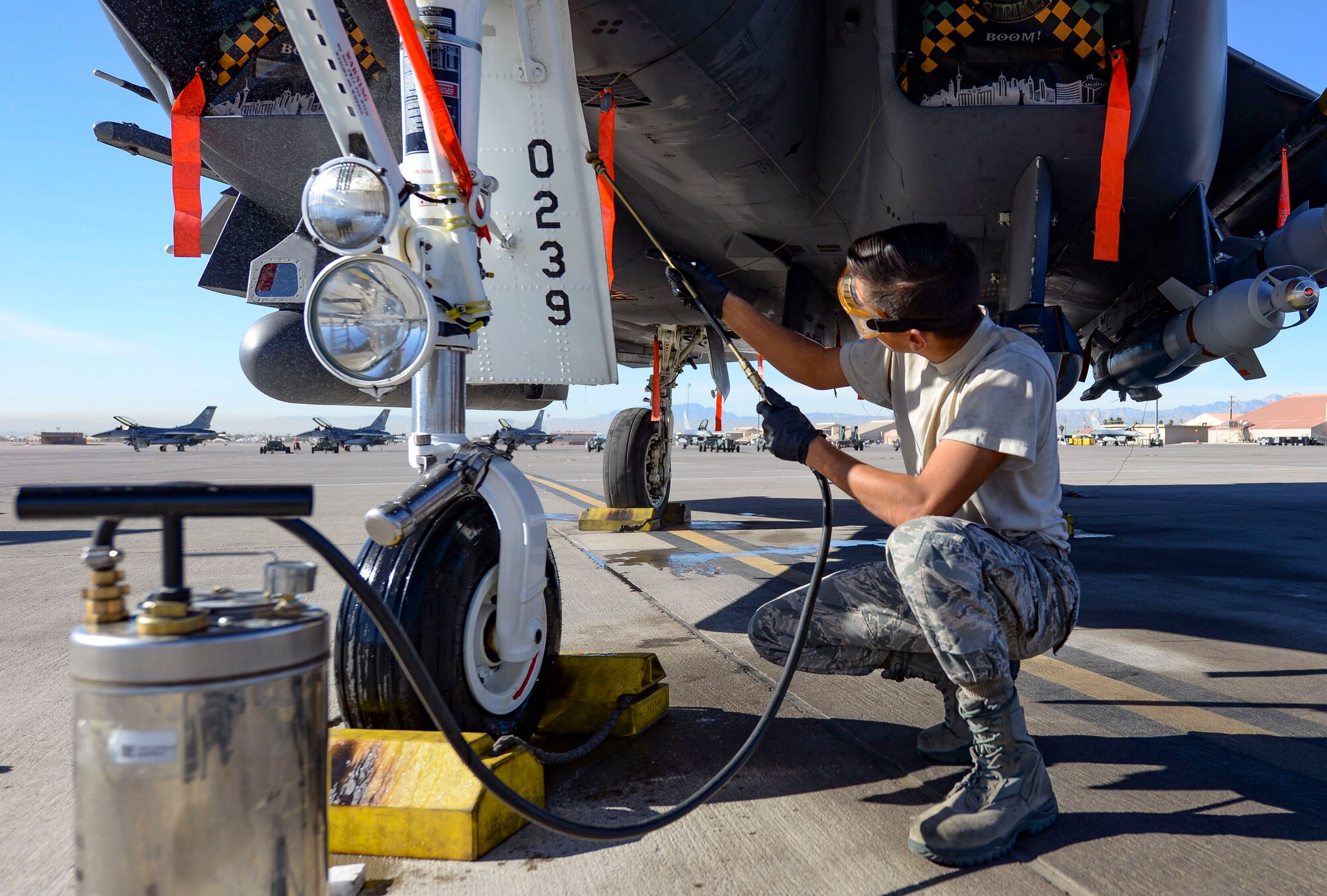 Airman 1st Class Bonifacio Garcia, 757th Aircraft Maintenance Squadron Strike Aircraft Maintenance Unit F-15E Strike Eagle fighter jet maintainer, cleans an F-15E landing gear while participating in a Gunsmoke Competition Nov. 15, 2018 at Nellis Air Force Base, Nevada. The Gunsmoke Competition has been brought back to Nellis to boost morale and readiness across the flightline. (U.S. Air Force photo by Airman Bailee A. Darbasie)