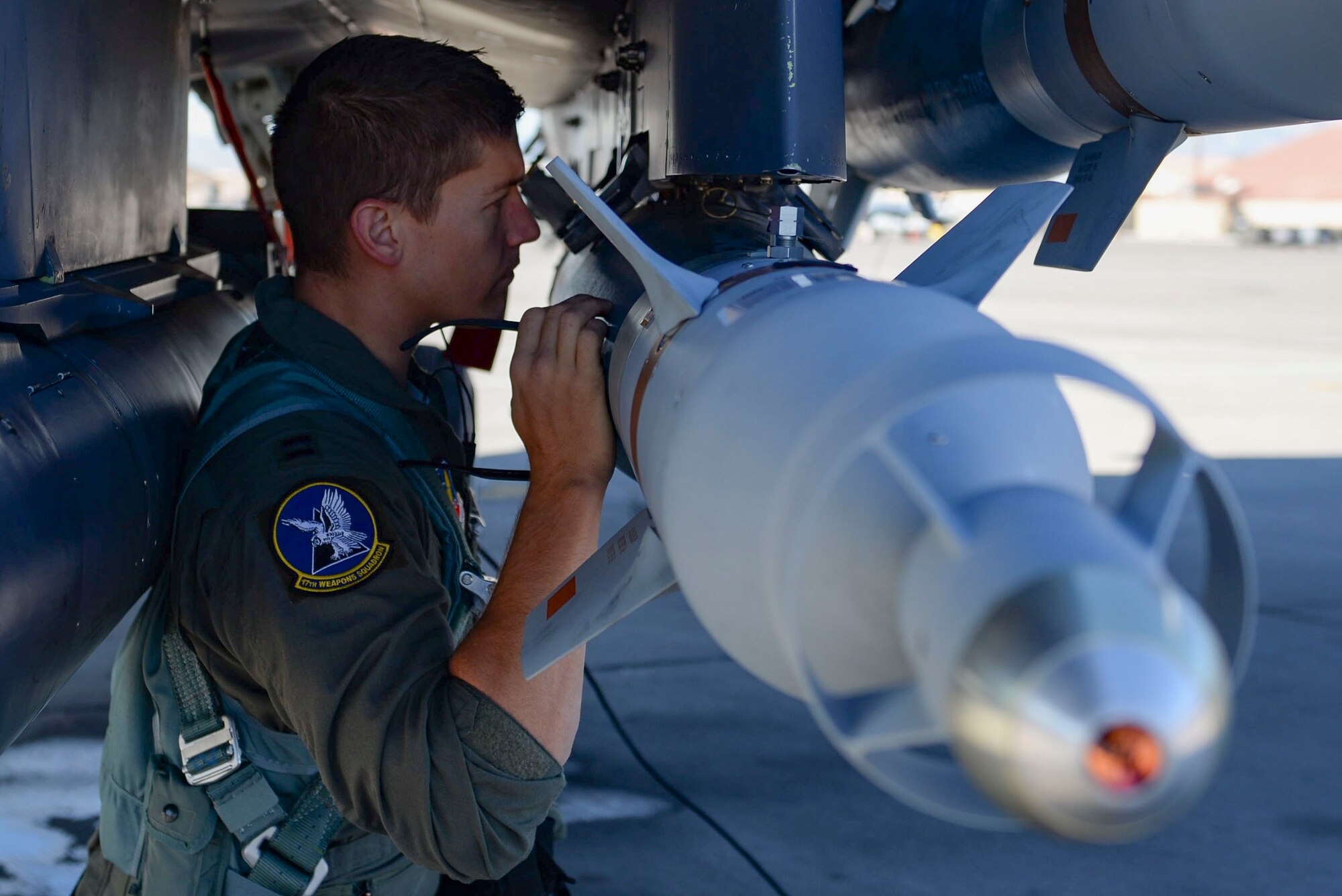 Capt. Andrew Griffin, 17th Weapons Squadron pilot, inspects an F-15E Strike Eagle fighter jet prior to his flight Nov. 15, 2018 at Nellis Air Force Base, Nevada. Pilots preform pre-flight inspections to ensure safety of both pilots and the aircraft during a flight. (U.S. Air Force photo by Airman Bailee A. Darbasie)