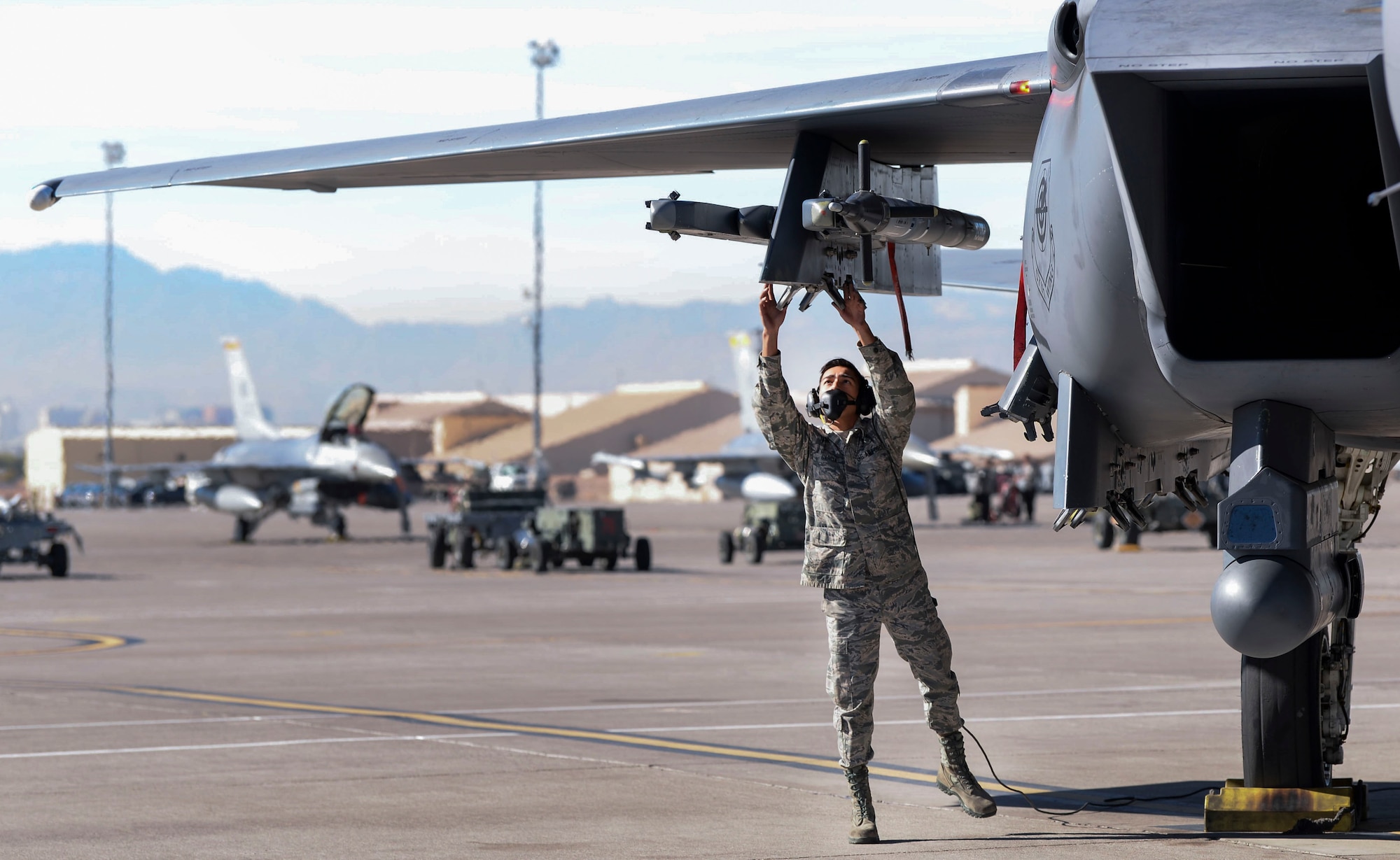 Airman 1st Class Bonifacio Garcia, 757th Aircraft Maintenance Squadron Strike Aircraft Maintenance Unit F-15E Strike Eagle fighter jet maintainer, inspects an F-15E before flight Nov. 15, 2018 at Nellis Air Force Base, Nevada. Crew chiefs are required to perform inspections prior to every launch. (U.S. Air Force photo by Airman Bailee A. Darbasie)