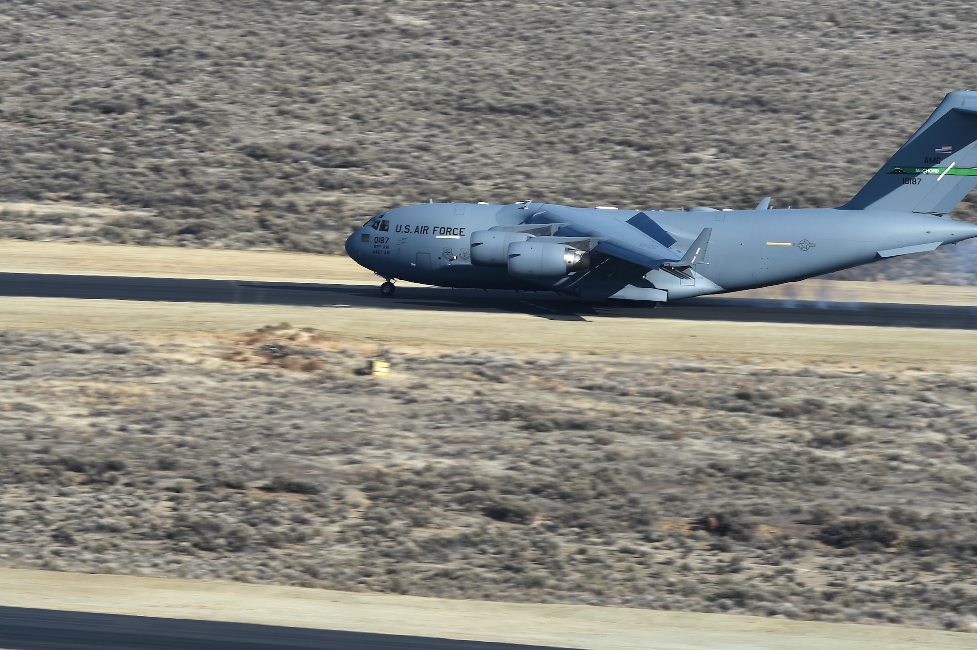 A McChord C-17 Globemaster III places the first skid marks on the new Selah Airstrip on the Yakima Training Center, Washington, November 15, 2018.