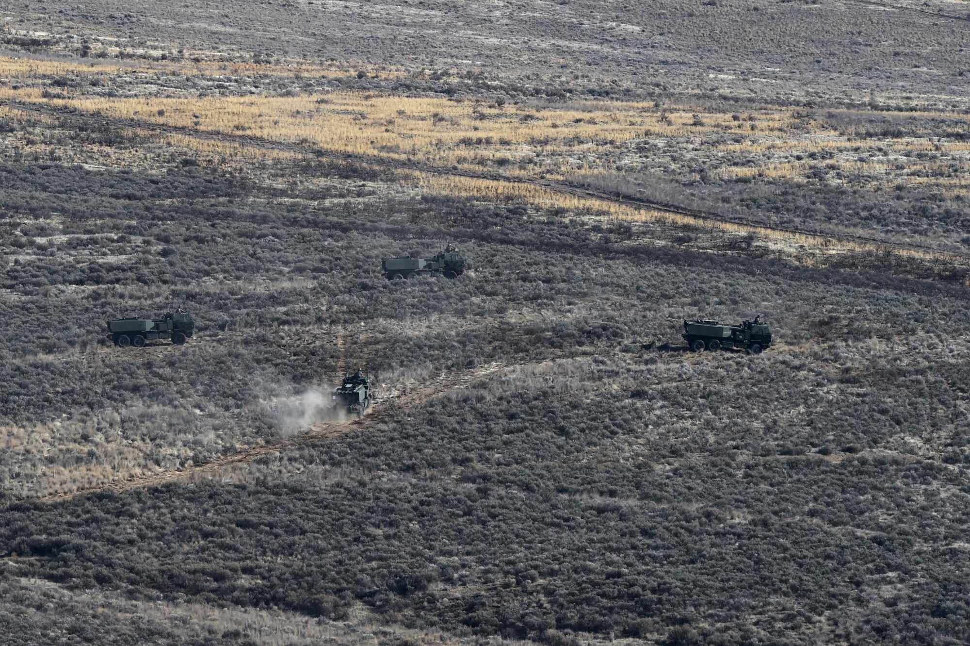 Four U.S. Army High Mobility Artillery Rocket System (HIMARS) vehicles get into position to fire rocket artillery as part of a training exercise and to celebrate the re-opening of the Selah Airstrip on Yakima Training Center, Washington, November 15, 2018.