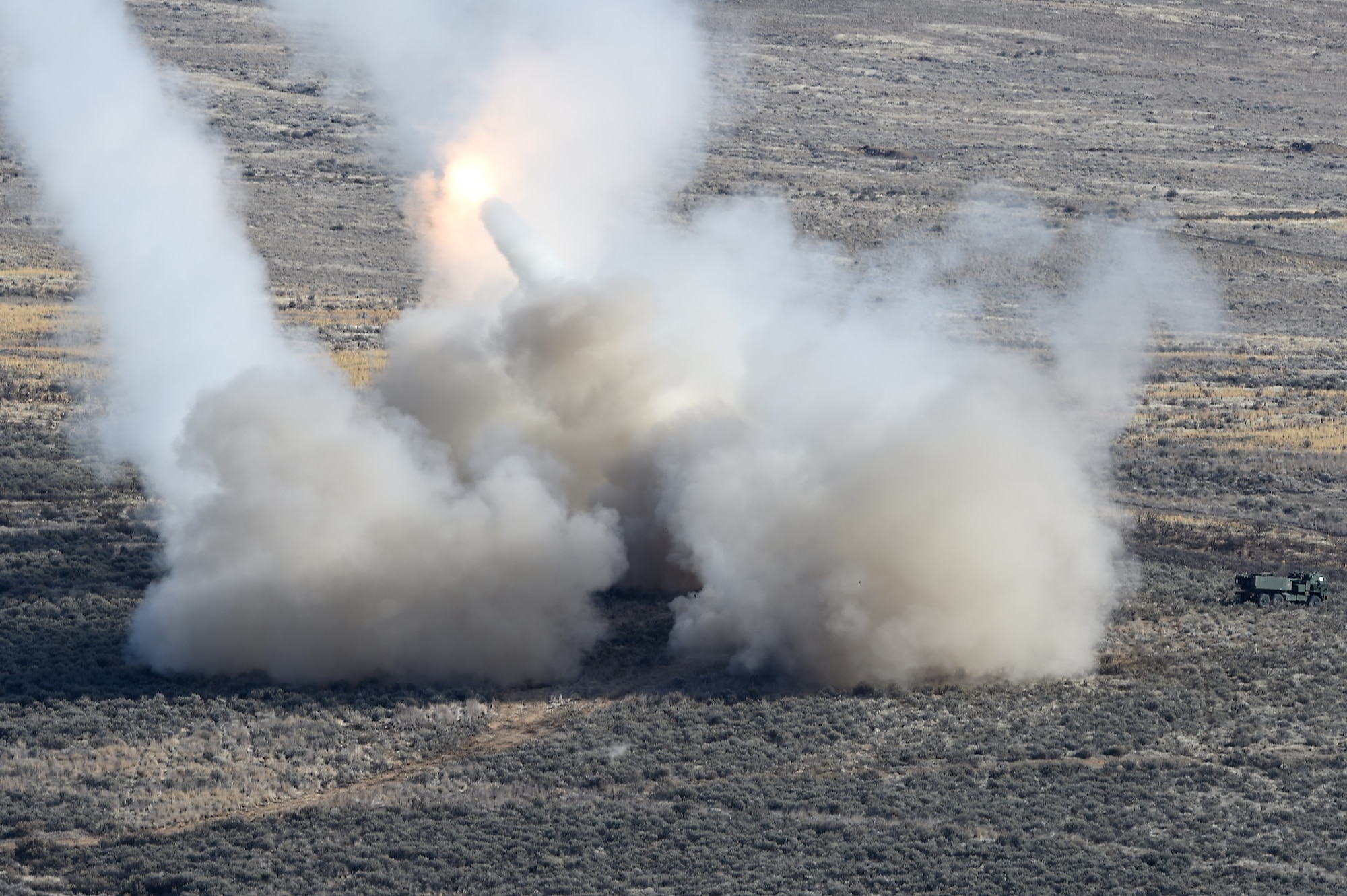 U.S. Army High Mobility Artillery Rocket System (HIMARS) vehicles fire rocket artillery as part of a training exercise and to celebrate the re-opening of the Selah Airstrip on Yakima Training Center, Washington, Novemeber 15, 2018.