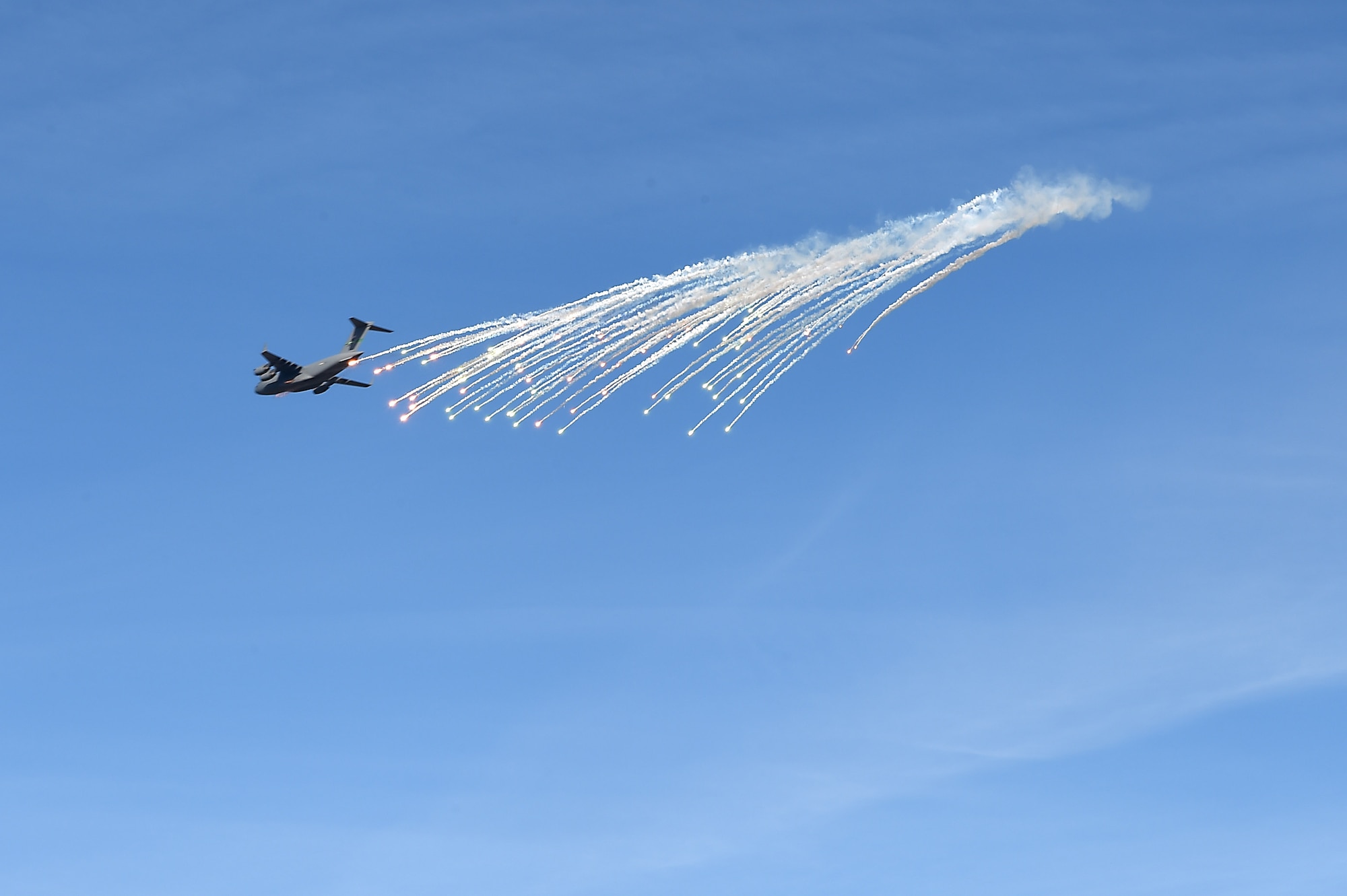 A McChord C-17 Globemaster III releases flares above the Selah Airstrip on Yakima Training Center, Washington, November 15, 2018.