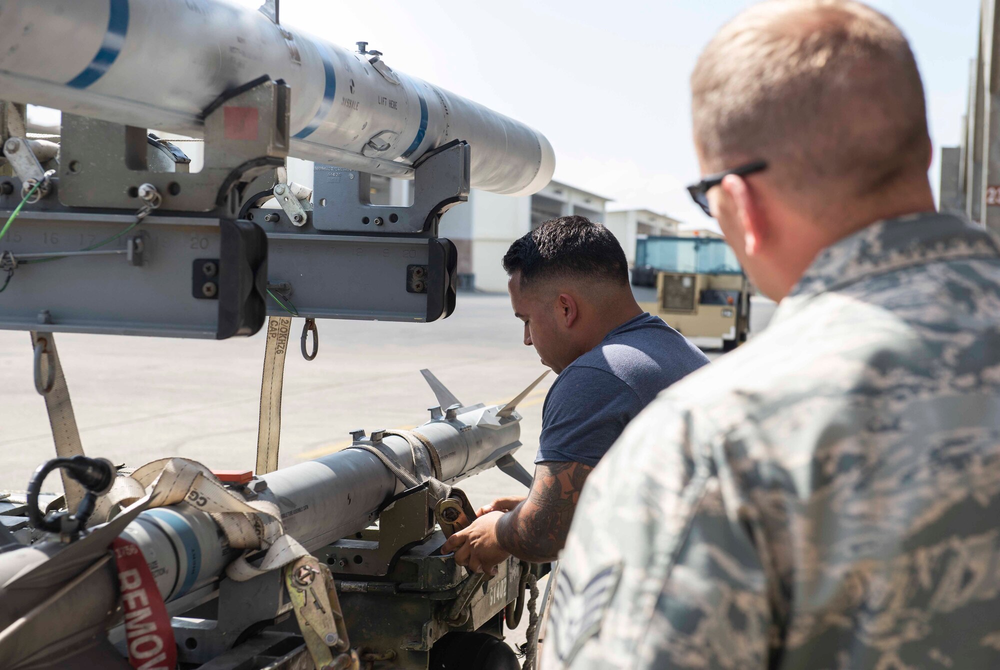 U.S. Air Force Staff Sgt. Eric Llaguno, 44th Aircraft Maintenance Unit weapons load crew chief, prepares to move munitions to an F-15 Eagle while being evaluated during a load competition Oct. 26, 2018, at Kadena Air Base, Japan. The 44th and 67th AMUs competed to see which unit loaded munitions in the best time.