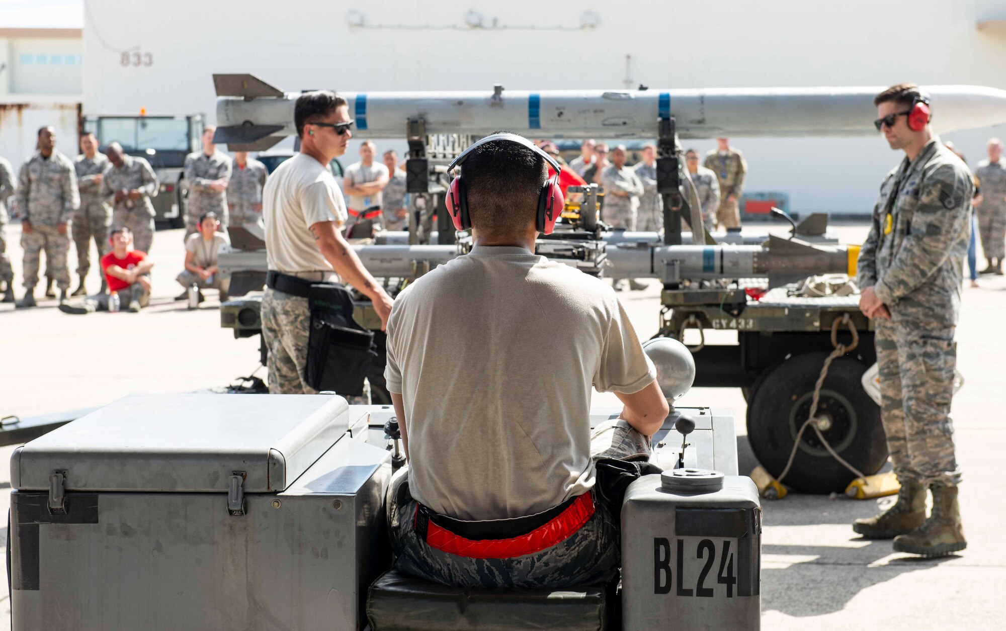 U.S Air Force Airman 1st Class Jordan Lazo, 67th Aircraft Maintenance Unit weapons load crew member, moves munitions during a load competition Oct. 26, 2018, at Kadena Air Base, Japan. The winner earns the title of the best AMU on base.
