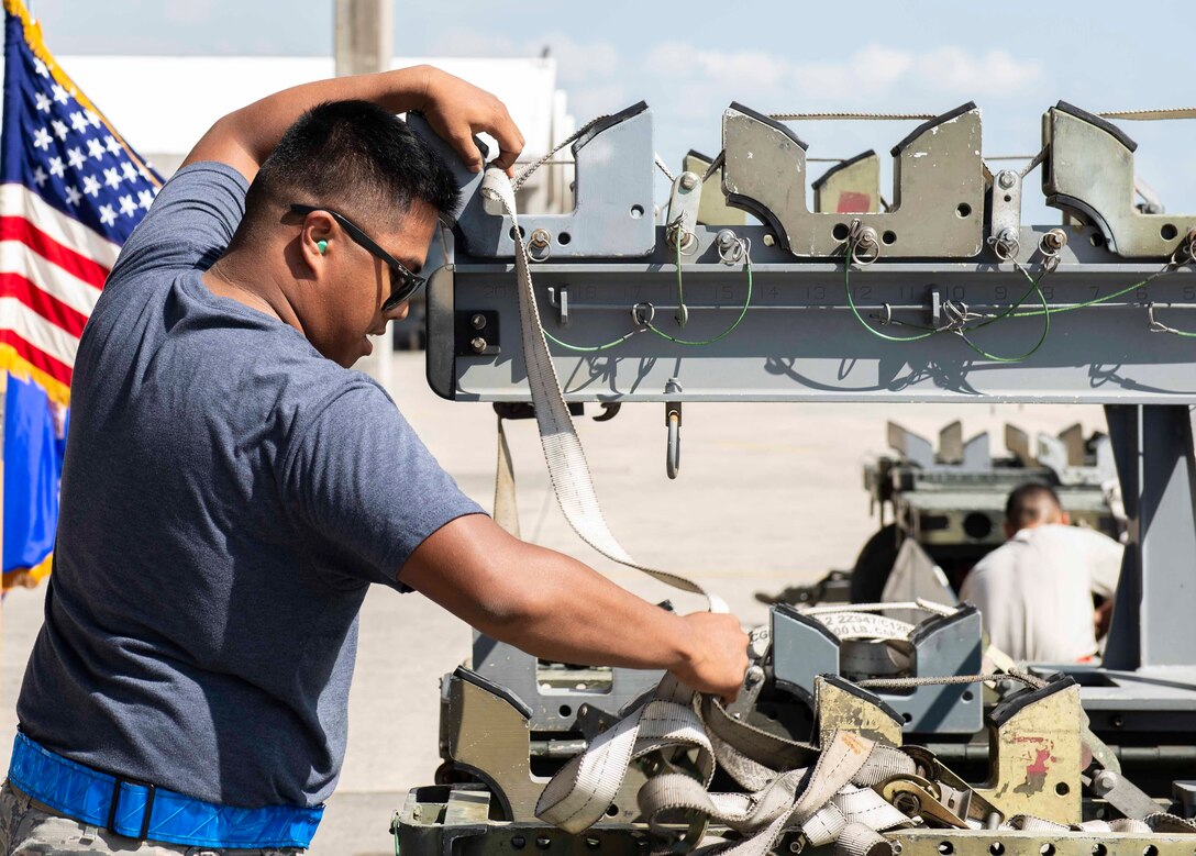 U.S Air Force Airman 1st Class Simon John Delaney, 44th Aircraft Maintenance Unit weapons load crew member, races against the clock to complete final tasks during a load competition Oct. 26, 2018, at Kadena Air Base, Japan. The units completed their tasks within mere seconds of each other.
