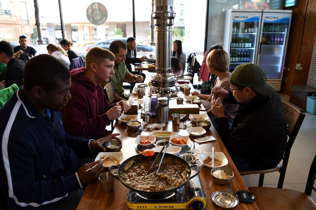 Members of Team Osan, along with local guides, enjoy a Korean lunch during the Head Start Program in Pyeongtaek, Republic of Korea, Nov. 11, 2018. The two-day program is designed to give ROK newcomers a first-hand look at Korean customs and culture, as well as imparting helpful information such as local laws. (U.S. Air Force photo by Senior Airman Kelsey Tucker)