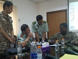 AMMAN, Jordan - Cpt. Melvin Obodoako, sustainment staff exchange team executive officer, 1st Theater Sustainment Command reviews with the Jordanian Armed Forces officers the running estimates for providing food and water support to a brigade of 4,500 Soldiers, at the JAF Logistics Headquarters, Sept. 16-20. (U.S. Army photo provided)