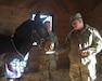 Maj.Gen. Flem "Donnie" Walker, Jr. Commanding General of the 1st Theater Sustainment Command feeds Cpl. John "Huck" Blackjack an alfalfa cookie in his stall at the Providence farm. Cpl. Blackjack serves as the 1st TSC official mascot, making appearances at many command events.