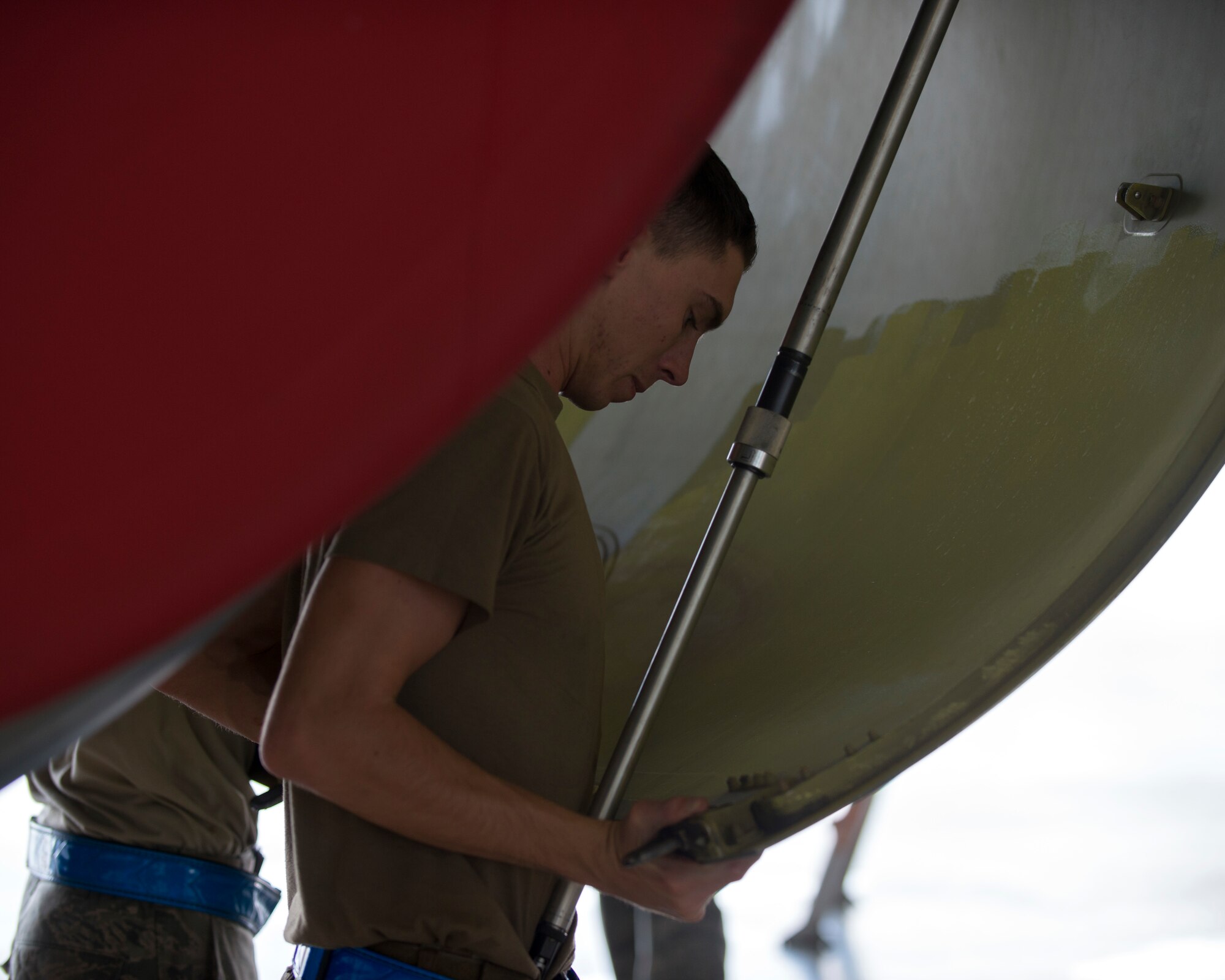 U.S. Air Force Airman 1st Class Caylor Jones, a 6th Aircraft Maintenance Squadron communications and navigation apprentice, closes a cowling on a KC-135 Stratotanker aircraft at MacDill Air Force Base, Fla., Nov. 19, 2018.