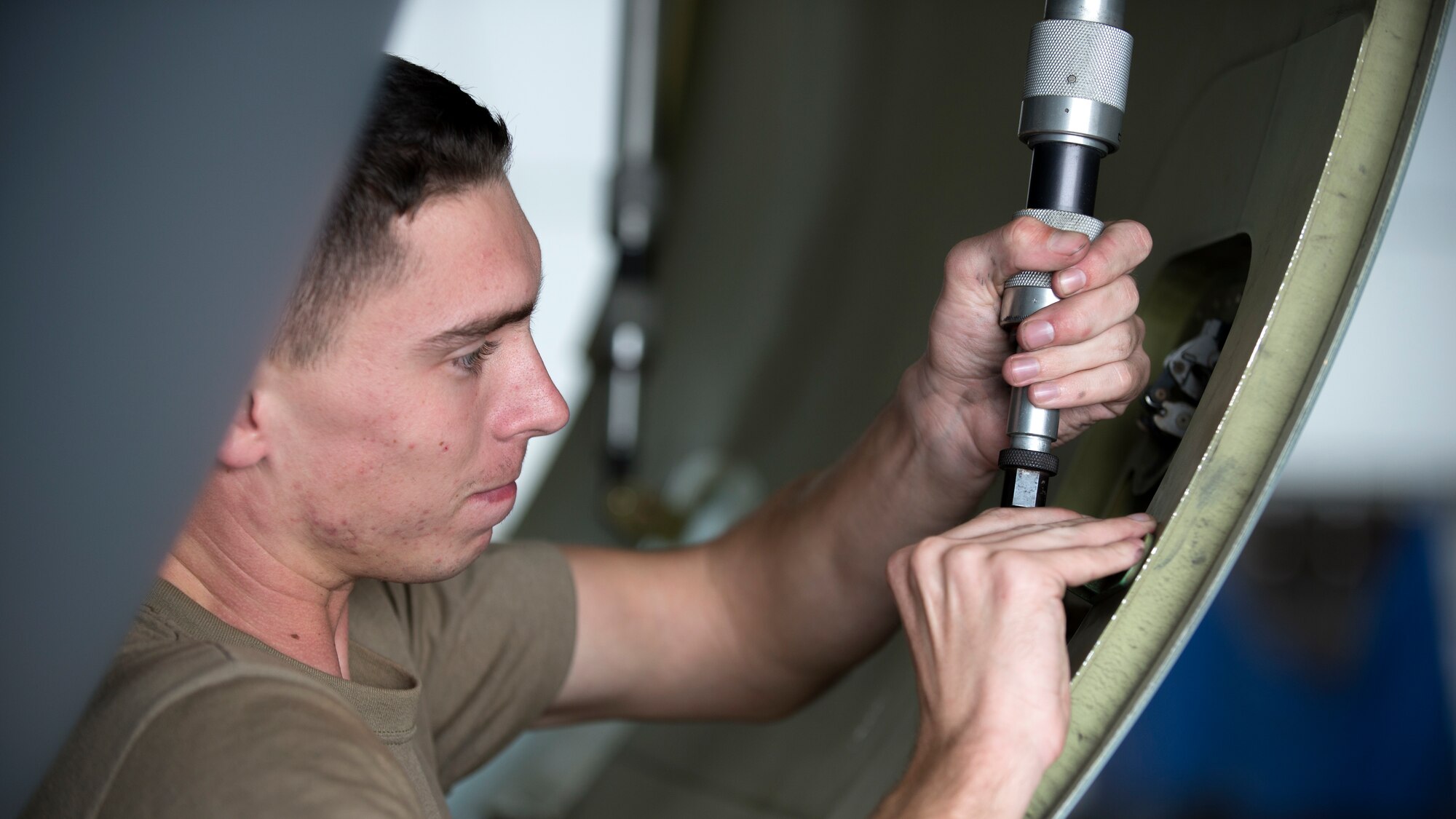 U.S. Air Force Airman 1st Class Caylor Jones, a 6th Aircraft Maintenance Squadron communications and navigation apprentice, unlatches a cowling door on a KC-135 Stratotanker aircraft at MacDill Air Force Base, Fla., Nov. 19, 2018.
