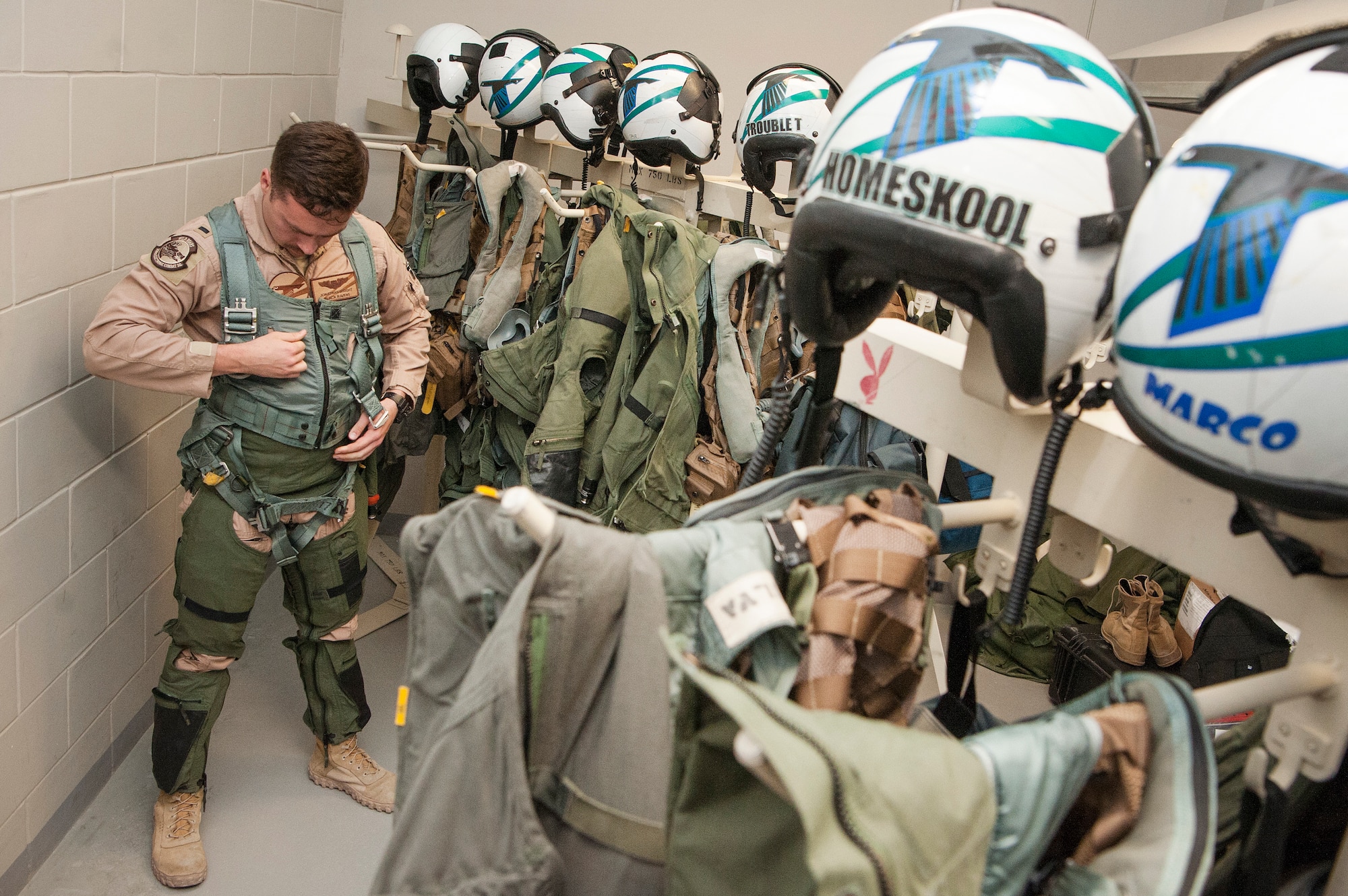 U.S. Air Force 1st Lt. Jonathan Wright, 390th Electronic Combat Squadron and Electronic Attack Squadron 135 (VAQ-135) “Black Ravens” EA-18G Growler pilot, dons his gear Nov. 20, 2018, at Al Udeid Air Base, Qatar. Wright is the first Air Force pilot to operate a Growler on a combat mission. VAQ-135 is deployed to the U.S. 5th Fleet area of operations in support of naval operations to ensure maritime stability and security in the Central Region, connecting the Mediterranean and the Pacific through the western Indian Ocean and three strategic choke points. (U.S. Air Force photo by Tech. Sgt. Christopher Hubenthal)