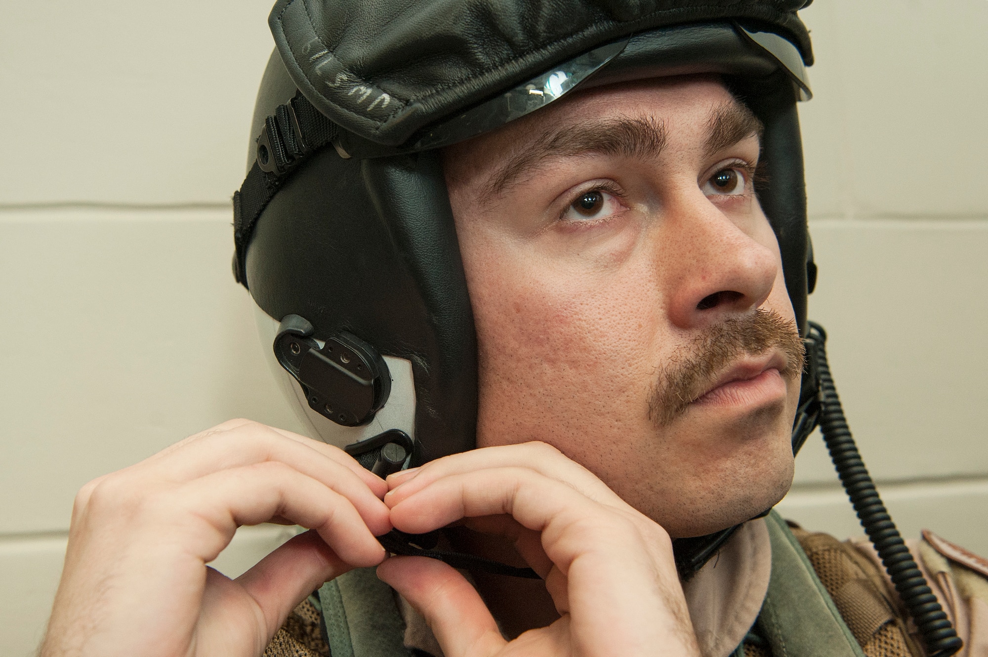 U.S. Air Force 1st Lt. Jonathan Wright, 390th Electronic Combat Squadron and Electronic Attack Squadron 135 (VAQ-135) “Black Ravens” EA-18G Growler pilot, dons his gear Nov. 20, 2018, at Al Udeid Air Base, Qatar. Wright is the first Air Force pilot to operate a Growler during real world operations. VAQ-135 is deployed to the U.S. 5th Fleet area of operations in support of naval operations to ensure maritime stability and security in the Central Region, connecting the Mediterranean and the Pacific through the western Indian Ocean and three strategic choke points. (U.S. Air Force photo by Tech. Sgt. Christopher Hubenthal)