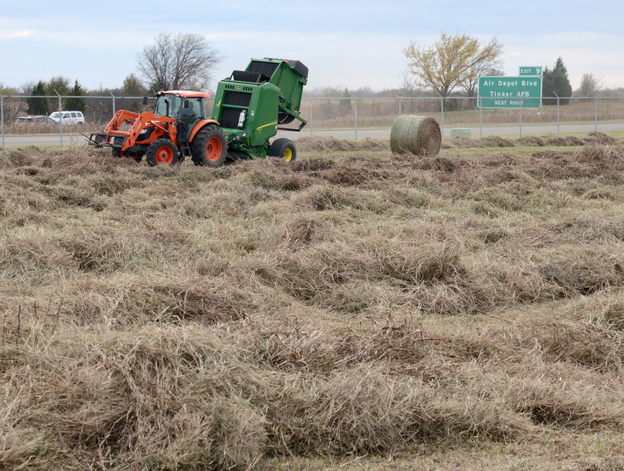 Hay is machine-baled on the land in front of Bldg. 9001 on Tinker AFB. In lieu of paying someone to mow the area, the land is leased for haying purposes. The lessee pays the government an annual fee and can keep the hay or sell it and keep the profit.