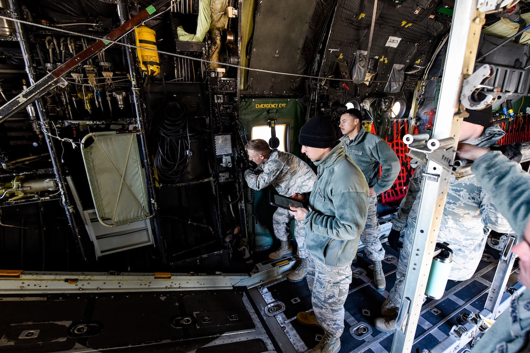 Sheppard Airmen in training work on a C-130 Hercules trainer jet.