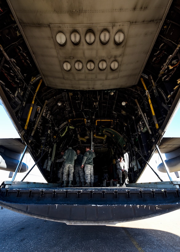 Sheppard Airmen in training work on a C-130 Hercules trainer jet.