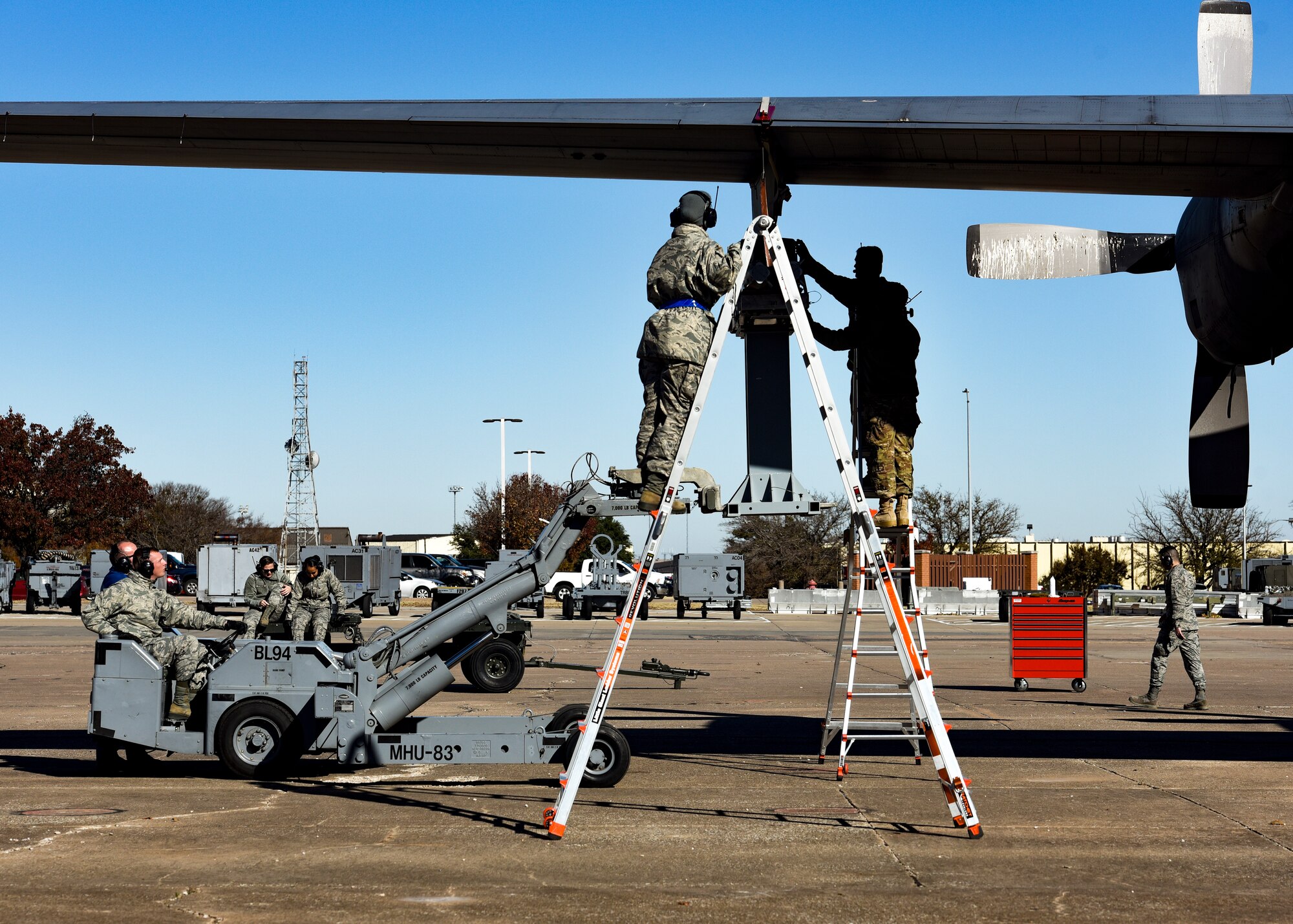 Sheppard Airmen in training work on a C-130 Hercules trainer jet.