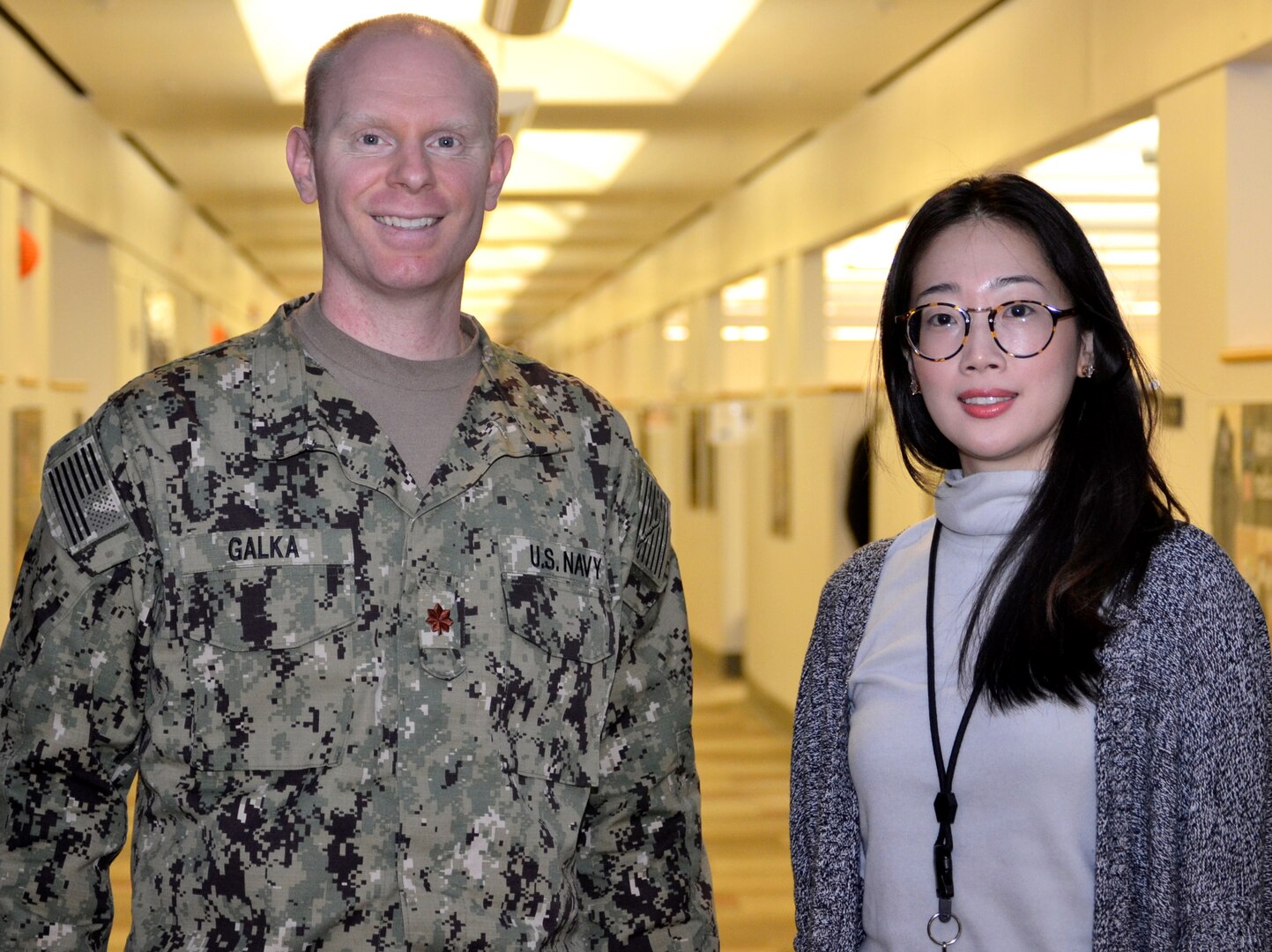 Navy Lt. Cmdr. Jason Galka, a Medical Customer Pharmacy Operations Center pharmacist, left, and Sooyun Kim, a Medical CPOC pharmacist, right, pose for a photo at DLA Troop Support, Nov. 21, 2018 in Philadelphia.