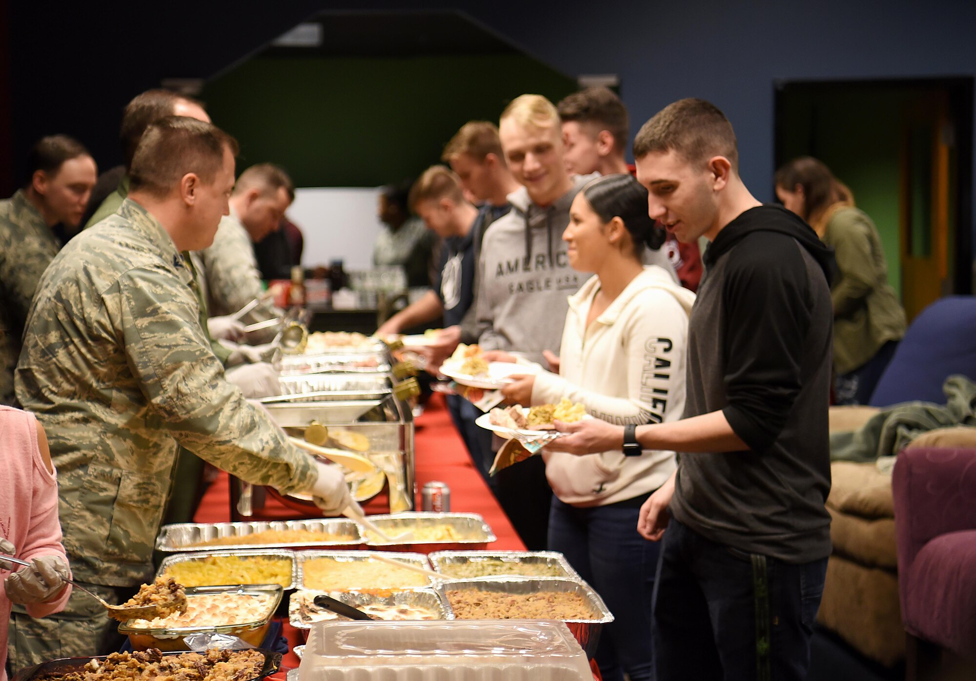 Enlisted Airmen prepare to eat a home-cooked meal Nov. 14, 2018, in the Montgomery Village on Columbus Air Force Base, Mississippi. Base private organizations banded together with Team BLAZE leadership to donate, prepare and serve an early Thanksgiving meal to Airmen who may not get to return home for the holidays. (U.S. Air Force photo by Airman 1st Class Keith Holcomb)