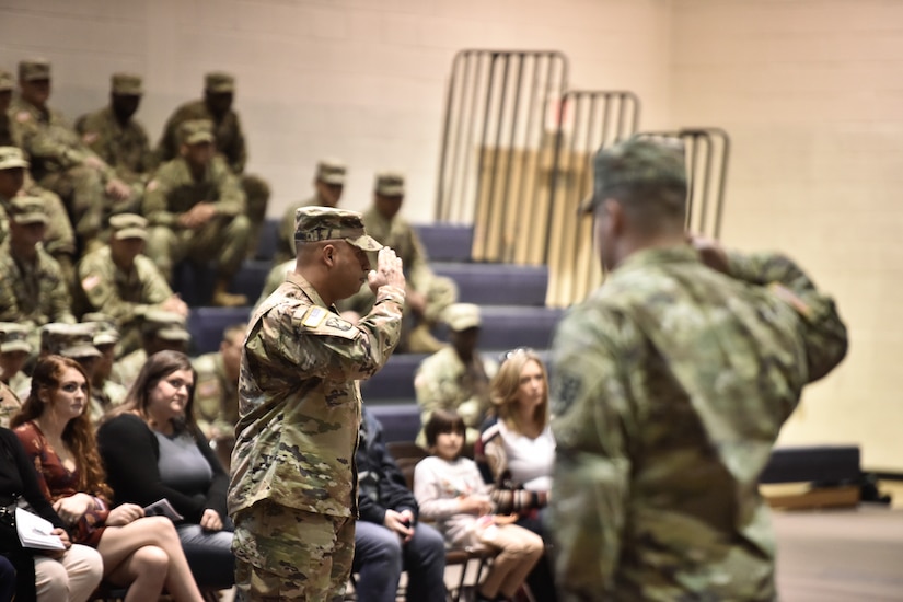 U.S. Army Capt. Francisco Gonzalez, 97th Transportation Company commander, renders a salute to the Soldiers who will deploy during a ceremony at Joint Base Langley-Eustis, Virginia, Nov. 20, 2018.  For some of the Soldiers this will not be their first deployment. (U.S. Army photo by Spc. Travis Teate)