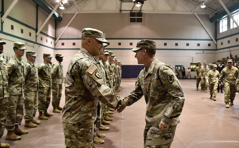 U.S. Army Col. Beth Behn, 7th Transportation Brigade (Expeditionary) commander, shakes hands with outgoing Warrant Officer, vessel master during a deployment ceremony at Joint Base Langley-Eustis, Virginia, Nov. 20, 2018.  Operation Spartan Shield is a nine month rotation in U.S. Central Command area of operation. (U.S. Army photo by Spc. Travis Teate)