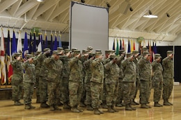 FORT KNOX, Ky. - The 1st Theater Sustainment Command Soldiers comprised of the Red Team and Alpha Company salute during the deployment ceremony at the Sadowski Center, Nov 19. The team, comprised of Soldiers and Department of the Army Civilians, deploying to Kuwait where they will assume the Strategic Operations and Plans (SOaP) mission. (U.S. Army photo by Spc. Zoran Raduka)