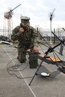 Navy Petty Officer 1st Class Albert A. Givens demonstrates how to set up a Mobile User Objective Service (MUOS), SATCOM system at Joint Task Force Civil Support (JTF-CS) on Nov. 19, 2018. The MUOS system enables military members to communicate in a crisis response. The JTF-CS anticipates either a large part of the civil communications infrastructure in and around catastrophic CBRN events will be destroyed, damaged, saturated or a combination of making reliance on the MUOS tactical system a mission-critical solution. When directed, JTF-CS is ready to respond in 24 hours to provide command and control of 5,200 federal military forces located at more than 36 locations throughout the nation in support of civil authority response operations to save lives, prevent further injury and provide critical support to enable community recovery. (Official DoD photo by U.S Air Force Tech. Sgt. Michael Campbell/ Released)