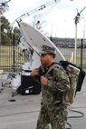 Navy Petty Officer 1st Class Albert A. Givens carries a complete communication Mobile User Objective Service (MUOS), SATCOM system at Joint Task Force Civil Support (JTF-CS) on Nov. 19, 2018. The MUOS system is a critical communication for any crises response. The light compact ability of the system can be used in a field or in transit operations. The MUOS system is ready for deployable conditions anywhere in the world. When directed, JTF-CS is ready to respond in 24 hours to provide command and control of 5,200 federal military forces located at more than 36 locations throughout the nation in support of civil authority response operations to save lives, prevent further injury and provide critical support to enable community recovery. (Official DoD photo by U.S Air Force Tech. Sgt. Michael Campbell/ Released)