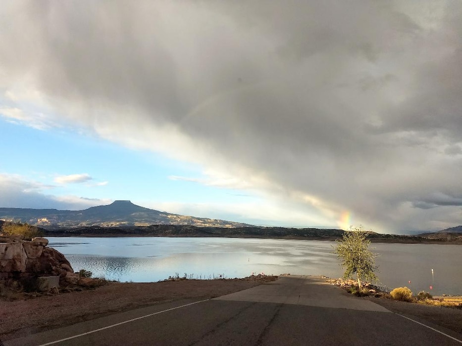 ABIQUIU LAKE, N.M. – A short span of a rainbow at the end of some storm clouds is seen from the boat ramp at the lake, Aug. 1, 2018. Photo by Clarence Maestas. This was a 2018 photo drive entry.